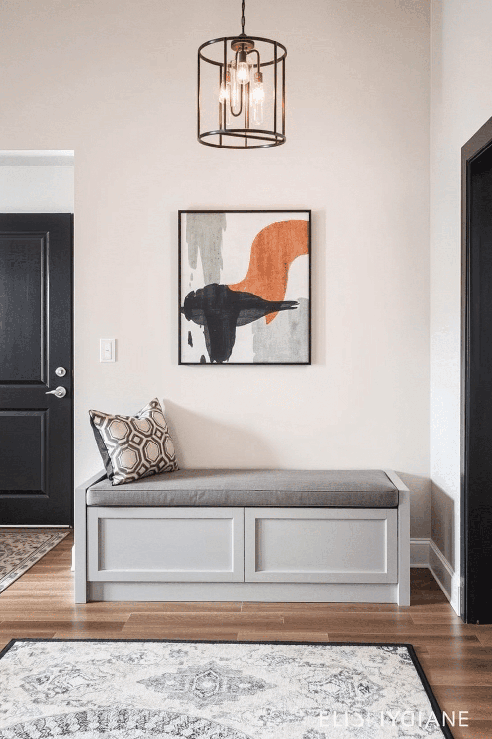 A stylish bench with hidden storage sits elegantly in the foyer, featuring a sleek upholstered seat in a soft gray fabric. The bench is designed with clean lines and a minimalist aesthetic, complemented by a pair of decorative pillows in a bold geometric pattern. The contemporary foyer showcases a striking combination of textures and materials, with a statement light fixture hanging above. A large abstract artwork adorns the wall, while a chic area rug adds warmth and defines the space, inviting guests into the home.