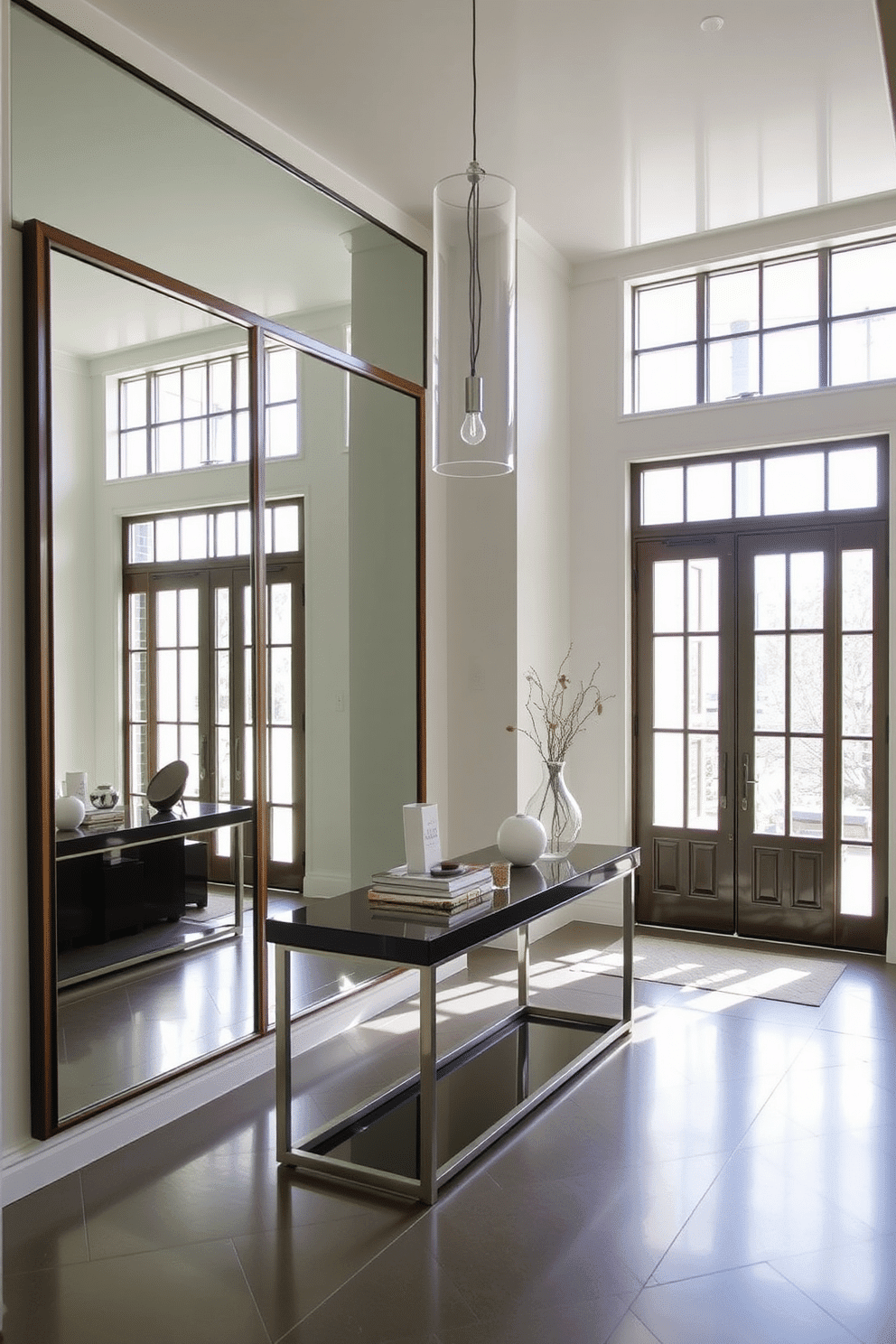 A contemporary foyer featuring large framed mirrors that reflect natural light, creating an inviting and airy atmosphere. The space is adorned with a sleek console table, topped with decorative items, and a stylish pendant light hangs from the ceiling, illuminating the entrance.