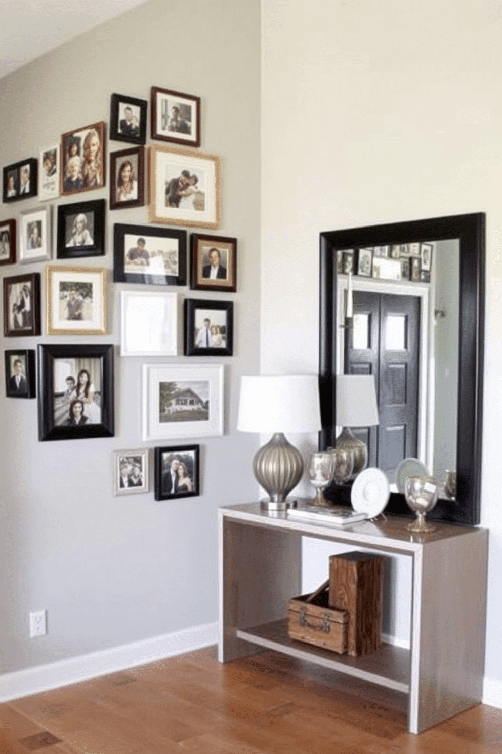 A gallery wall filled with framed family photos creates a warm and inviting atmosphere. The frames vary in size and style, arranged in a cohesive layout against a soft gray backdrop. The foyer features a sleek console table with a modern lamp and decorative accents. A large mirror above the table reflects natural light, enhancing the space's openness and elegance.