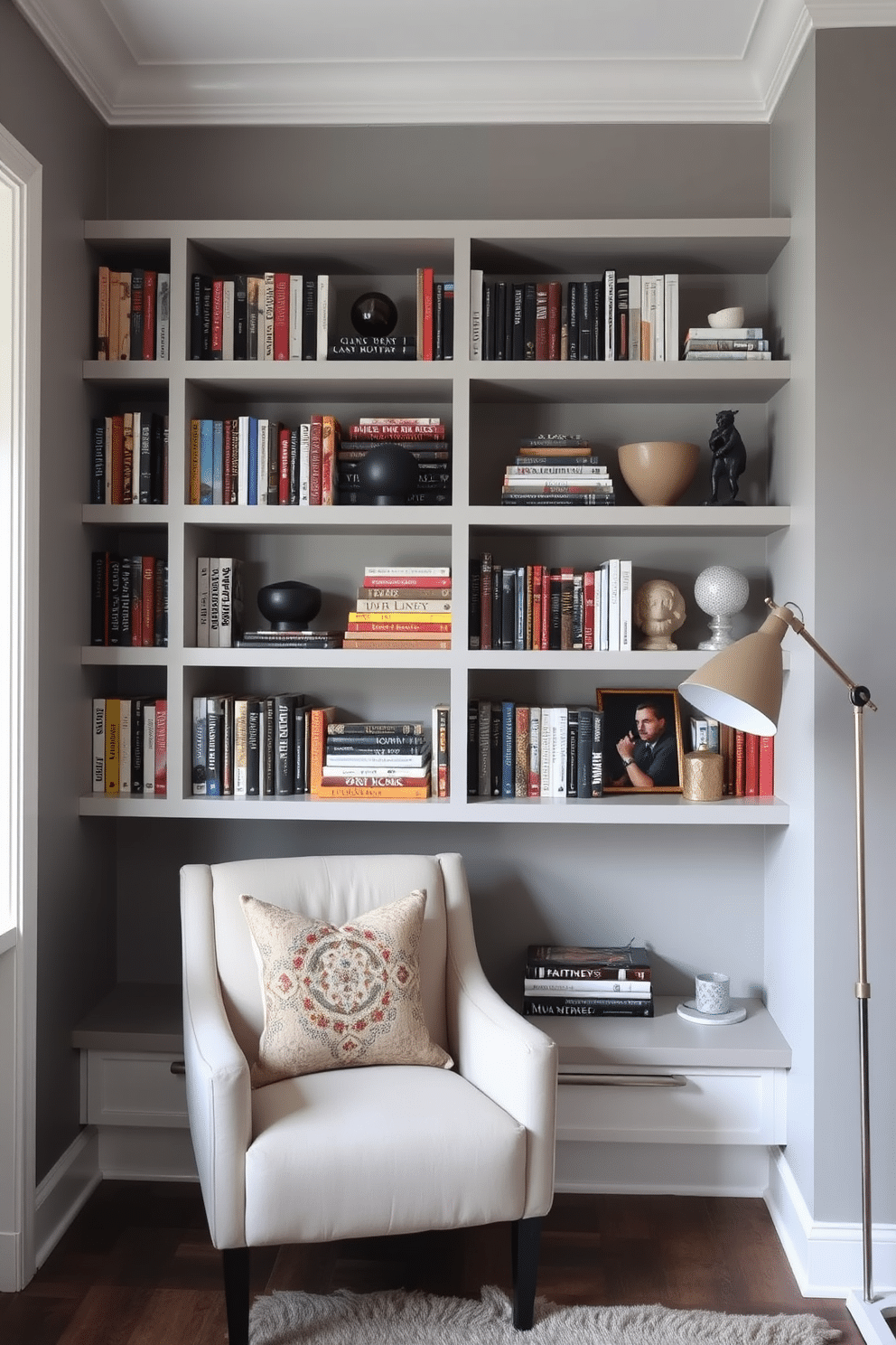 A contemporary home library features sleek floating shelves that display an array of books and decorative items. The walls are painted in a soft gray, complemented by a cozy reading nook with a plush armchair and a stylish floor lamp.