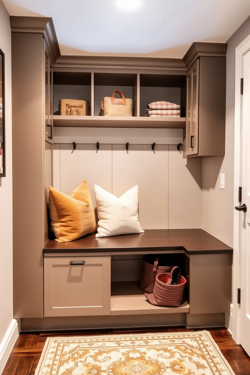 A contemporary mudroom features a built-in bench adorned with cozy cushions in soft, earthy tones. The space is designed with sleek cabinetry and hooks for storage, complemented by a stylish area rug that adds warmth and character.