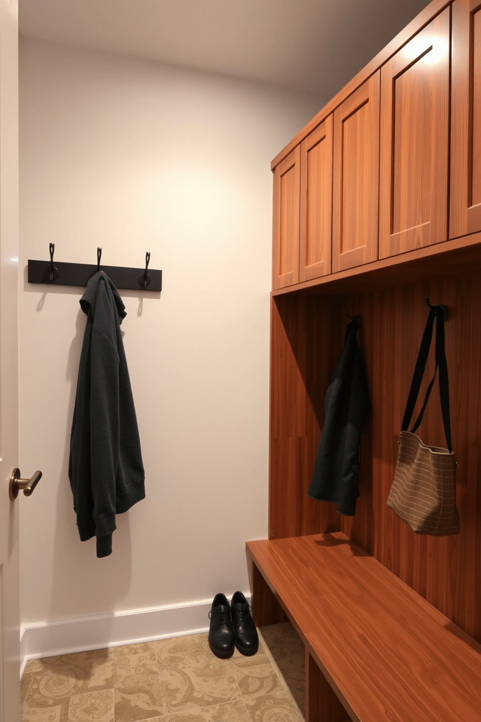 A contemporary mudroom features hooks with integrated lighting for enhanced visibility, creating a functional yet stylish space. The walls are adorned with sleek cabinetry in a warm wood finish, and the floor is covered with durable, patterned tiles that withstand heavy foot traffic.