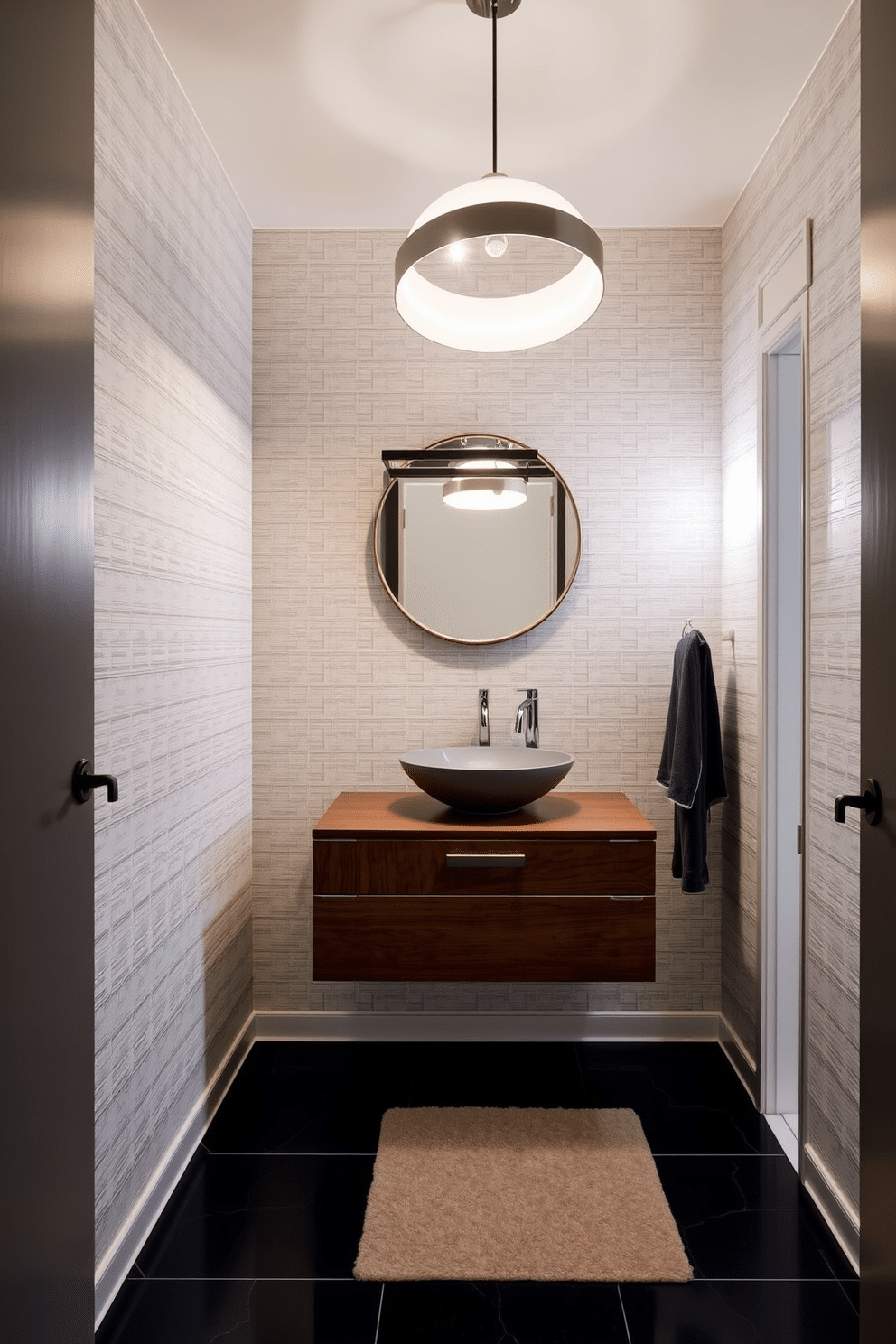 A contemporary powder room features bold, creative lighting fixtures that serve as statement pieces, drawing attention to the space. The walls are adorned with a textured wallpaper in a soft gray, while the floor is finished with sleek black tiles that enhance the modern aesthetic. A stylish floating vanity in a rich walnut finish complements the space, topped with a striking vessel sink. Above the vanity, an oversized, artistic pendant light casts a warm glow, creating an inviting atmosphere for guests.