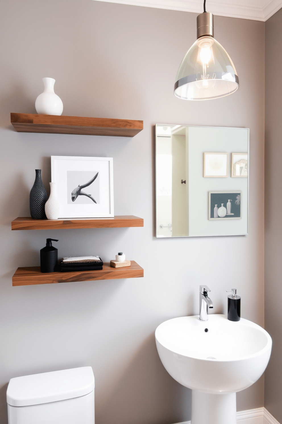 A sleek contemporary powder room features floating shelves on the wall, adorned with a curated selection of decorative items, including vases and art pieces. The walls are painted in a soft gray, complementing the modern fixtures and a stylish sink that sits below a large mirror. The floating shelves are crafted from reclaimed wood, adding warmth to the minimalist design. A statement pendant light hangs above, casting a warm glow that highlights the elegant decor and creates an inviting atmosphere.