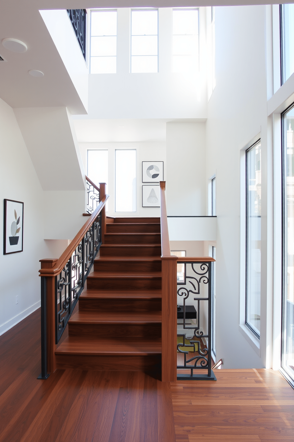 A contemporary staircase featuring elegant metalwork details. The railing boasts intricate geometric patterns, complemented by a sleek wooden handrail that adds warmth to the design. The staircase treads are crafted from rich hardwood, leading up to a spacious landing bathed in natural light from large windows. The walls are adorned with minimalist artwork, enhancing the modern aesthetic of the space.