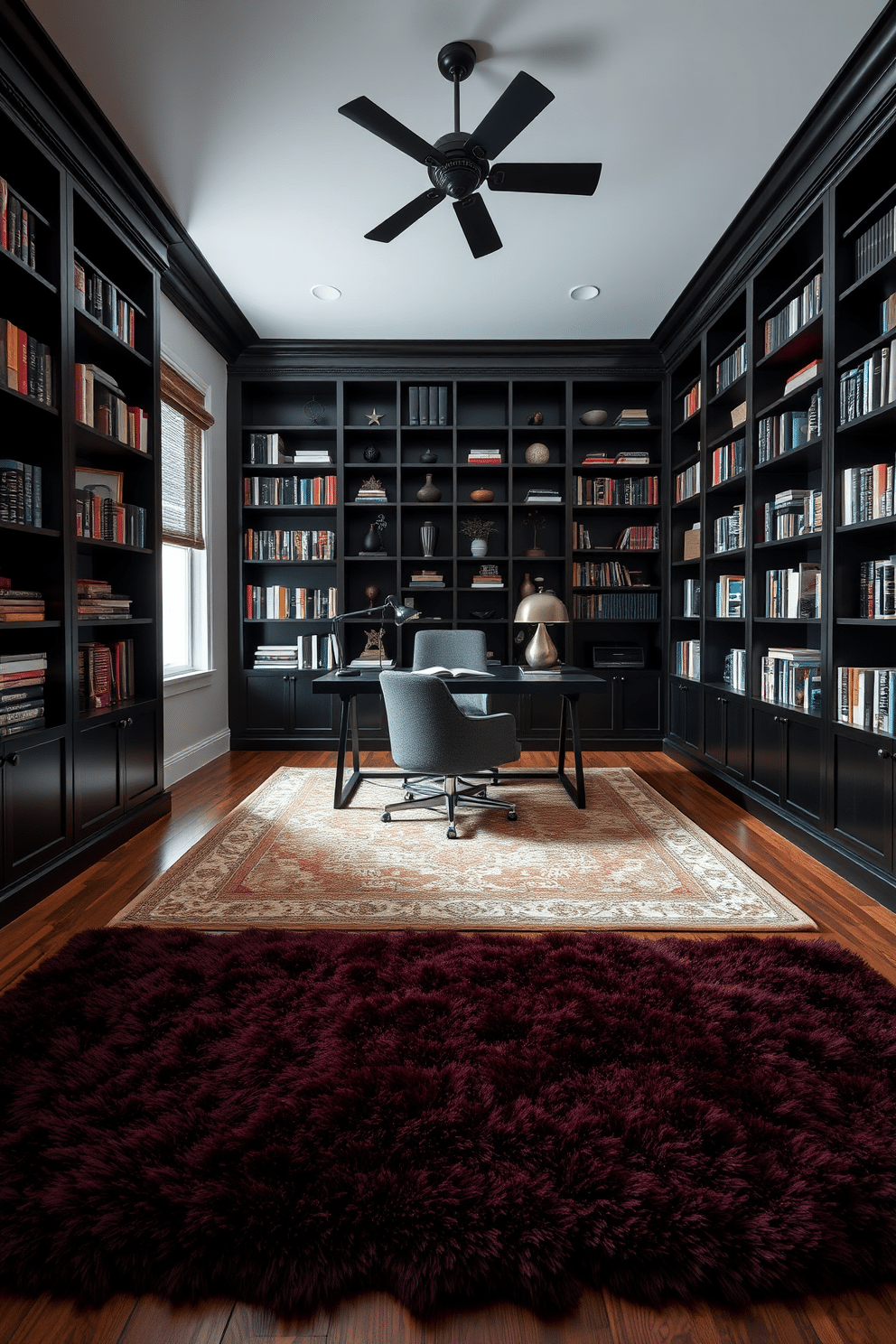 A dark study room exuding a cozy and sophisticated atmosphere. The space features layered rugs in rich textures, with a plush, deep burgundy rug layered over a larger, patterned area rug in muted tones. Dark wood bookshelves line the walls, filled with an array of books and decorative objects. A sleek, modern desk sits in the center, accompanied by a comfortable, upholstered chair in a complementary dark fabric.