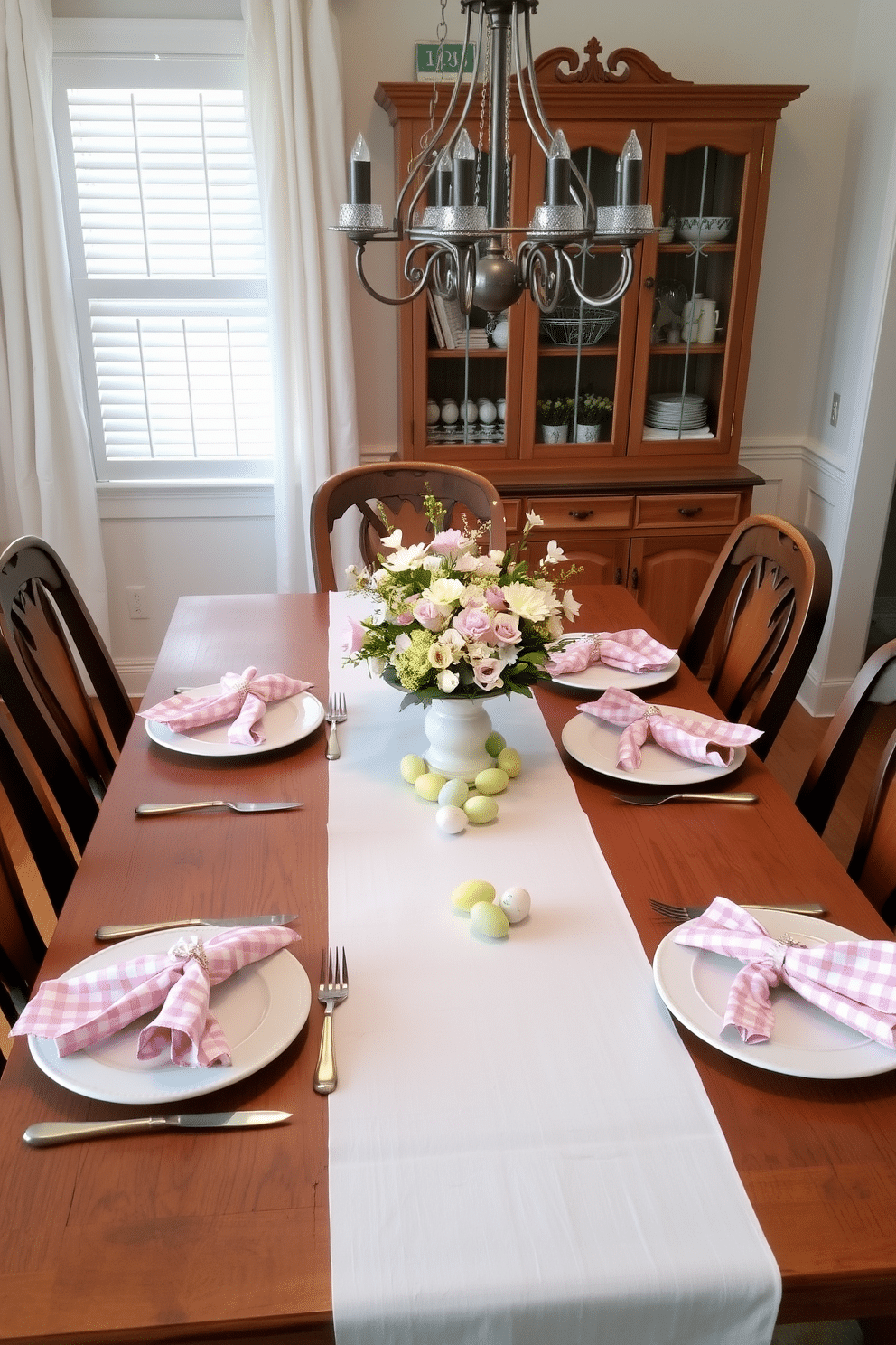 A charming dining room set for Easter, featuring a rustic wooden table adorned with a white tablecloth. Gingham napkins in pastel colors are neatly folded and placed beside each plate, adding a festive touch to the setting. The centerpiece consists of a floral arrangement in soft hues, complemented by small decorative eggs scattered around. Soft lighting from a nearby chandelier casts a warm glow, enhancing the inviting atmosphere of the room.