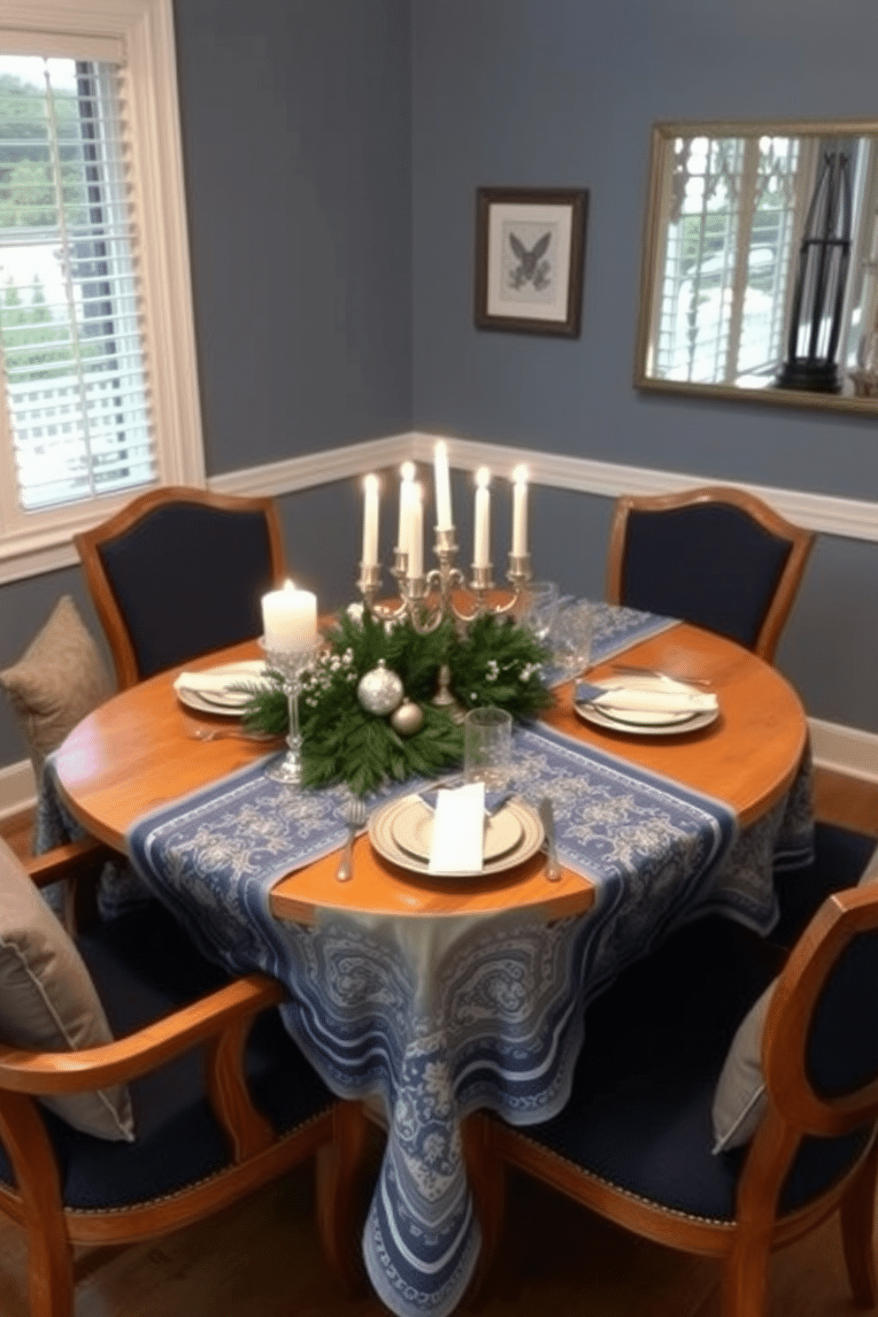 A cozy dining room featuring cushioned chairs that invite comfort and relaxation. The chairs are upholstered in a rich navy fabric, perfectly complementing the warm wooden dining table set for a festive Hanukkah celebration. The table is adorned with a beautiful blue and white tablecloth, with shimmering silver accents that reflect the light of the candles. Centered on the table is a decorative menorah, surrounded by fresh greenery and elegant place settings that enhance the holiday spirit.