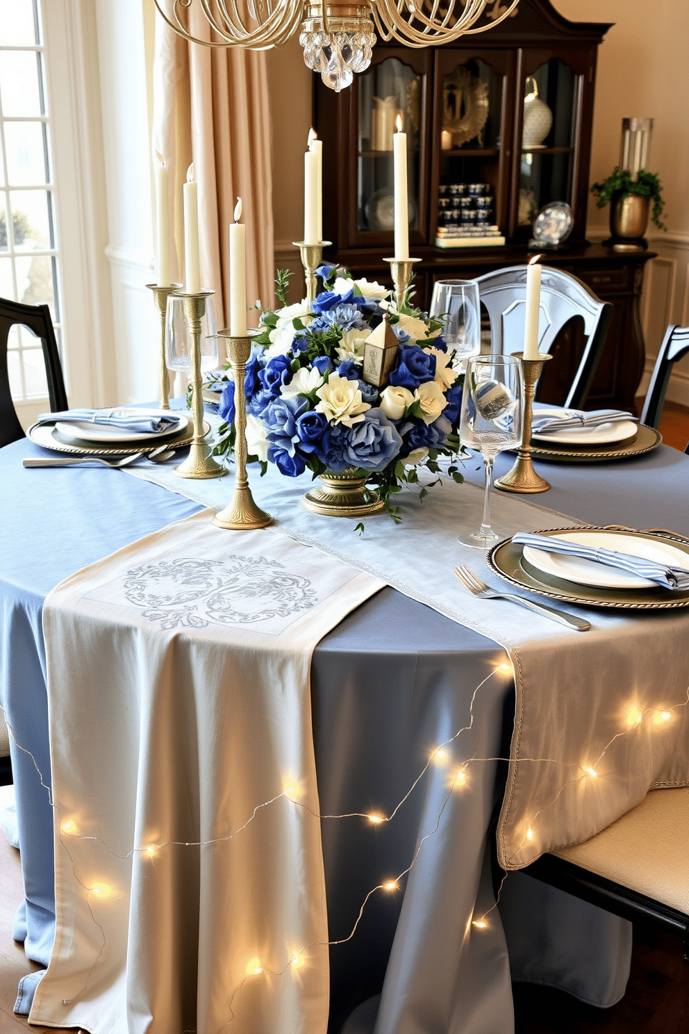 A beautifully set dining table adorned with layered table runners in varying textures, featuring a mix of linen and velvet in soft shades of blue and silver. The runners cascade elegantly down the table, creating a rich visual depth that complements the shimmering candle holders and festive dinnerware. For Hanukkah, the dining room is decorated with a stunning centerpiece of blue and white flowers, surrounded by traditional menorah and dreidel accents. Twinkling fairy lights are draped along the table's edge, enhancing the warm and inviting atmosphere for family gatherings.