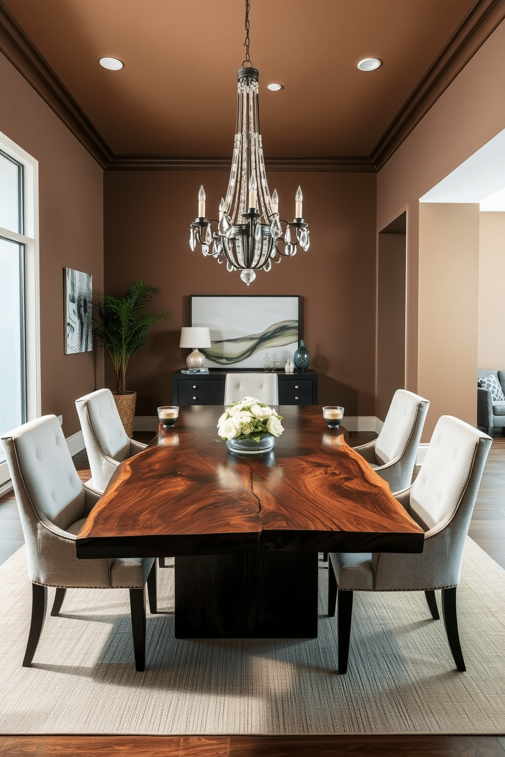 A stunning dining room featuring a live edge table made from rich, dark wood, showcasing the natural grain and unique contours. Surrounding the table are elegant, upholstered chairs in a soft, neutral fabric that complement the organic aesthetic of the space. The walls are painted in a warm, earthy tone, enhancing the inviting atmosphere of the room. A statement chandelier hangs above the table, providing ambient lighting and adding a touch of sophistication to the overall design.