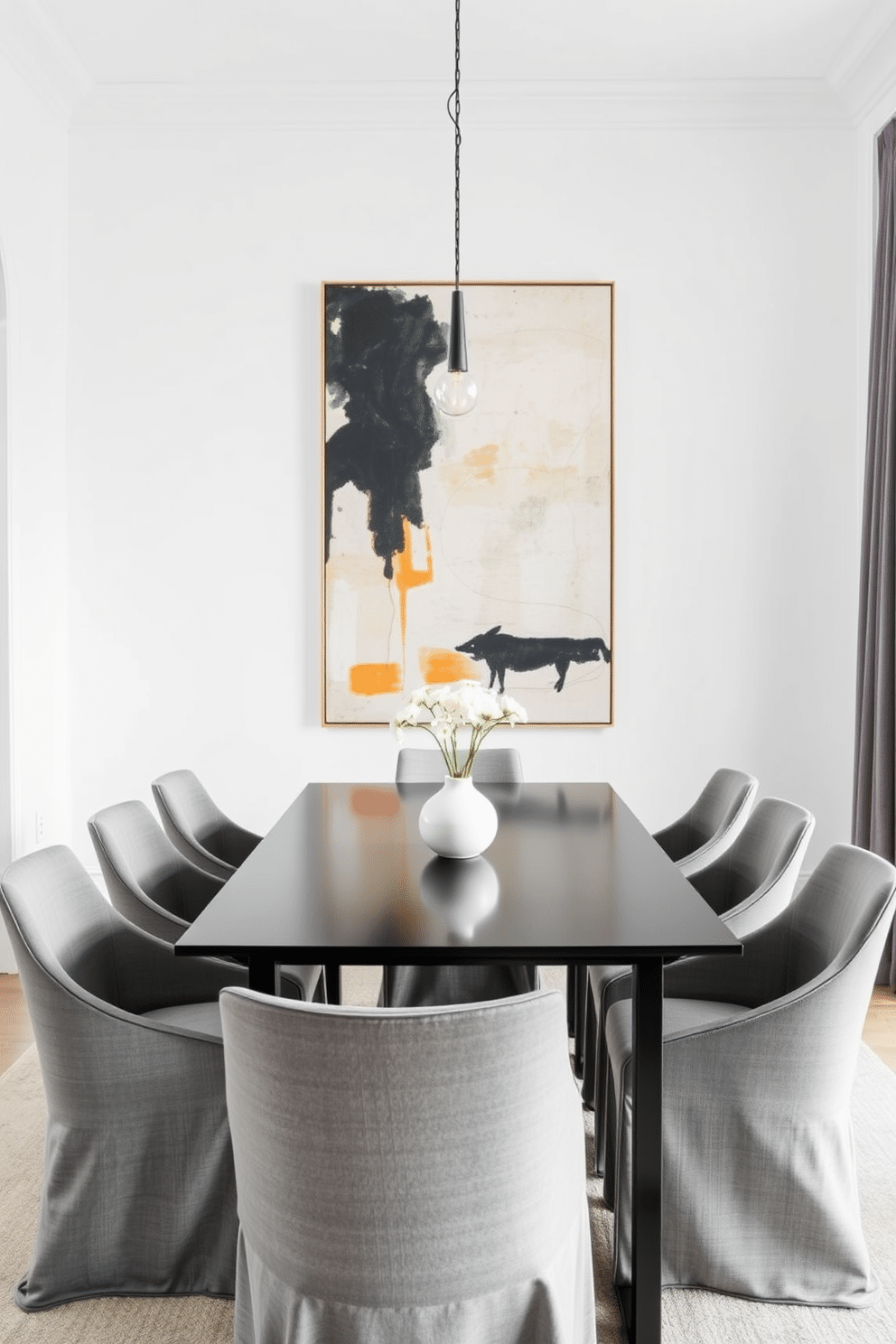 A minimalist dining room featuring a sleek black metal dining table surrounded by elegant upholstered chairs in a soft gray fabric. The walls are painted in a crisp white, and a large abstract painting adds a pop of color above the table, enhancing the modern aesthetic.