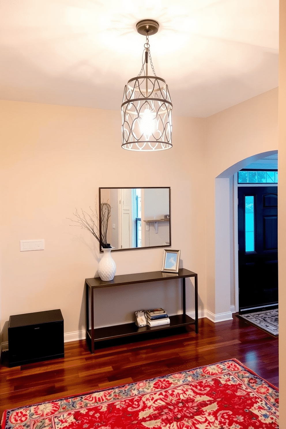 A bright pendant light hangs elegantly from the ceiling in the entryway, casting a warm glow across the space. The light features a modern design with intricate details, creating a stunning focal point that draws the eye. The entryway is adorned with a sleek console table, topped with decorative accents like a stylish vase and a small mirror. Soft, neutral tones on the walls complement the rich wood flooring, while a vibrant area rug adds a pop of color and texture.