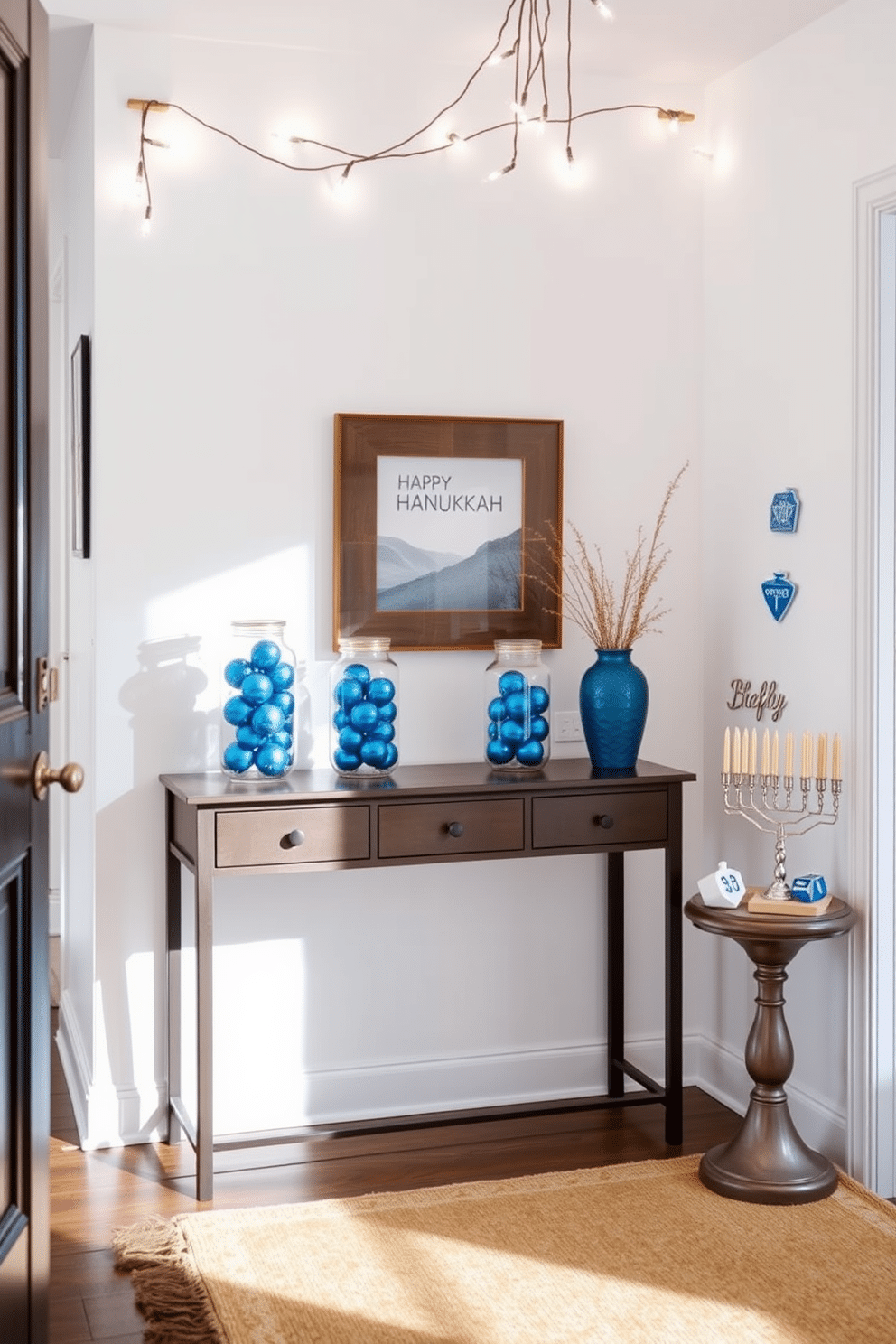 A stylish entryway featuring a console table adorned with decorative jars filled with blue ornaments. The walls are painted in a soft white hue, and a warm, inviting rug lies beneath the table, enhancing the festive atmosphere. To the side, a beautifully arranged display of menorahs and dreidels complements the blue accents. Twinkling string lights are draped above, creating a cozy and celebratory ambiance for Hanukkah celebrations.