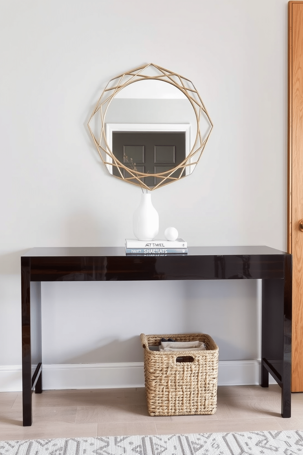 A stylish mirror with a geometric design hangs above a sleek console table made of dark wood. The table is adorned with a minimalist vase and a small stack of art books, creating an inviting focal point in the entryway. The console table features a glossy finish that reflects light, enhancing the brightness of the space. Beneath the table, a woven basket adds texture and provides practical storage for shoes or accessories.