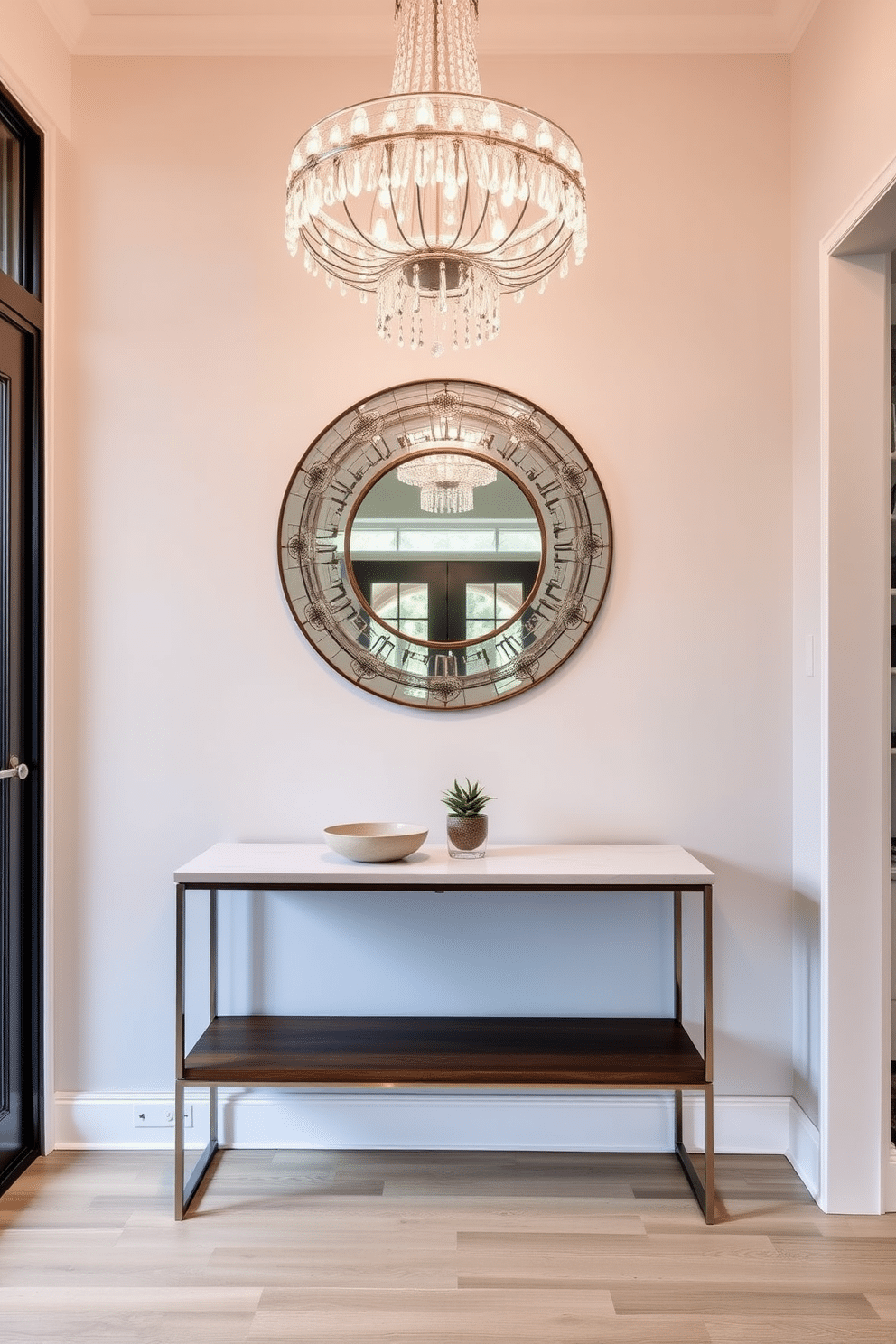 A stunning chandelier made of crystal hangs from the ceiling, casting a warm glow throughout the entryway. Below, a sleek console table in a rich walnut finish showcases a decorative bowl and a small potted plant, enhancing the welcoming atmosphere. The entryway table features a minimalist design with clean lines and a white marble top, paired with stylish metal legs for a modern touch. Above the table, a large round mirror with an ornate frame reflects natural light, creating a sense of depth and space.