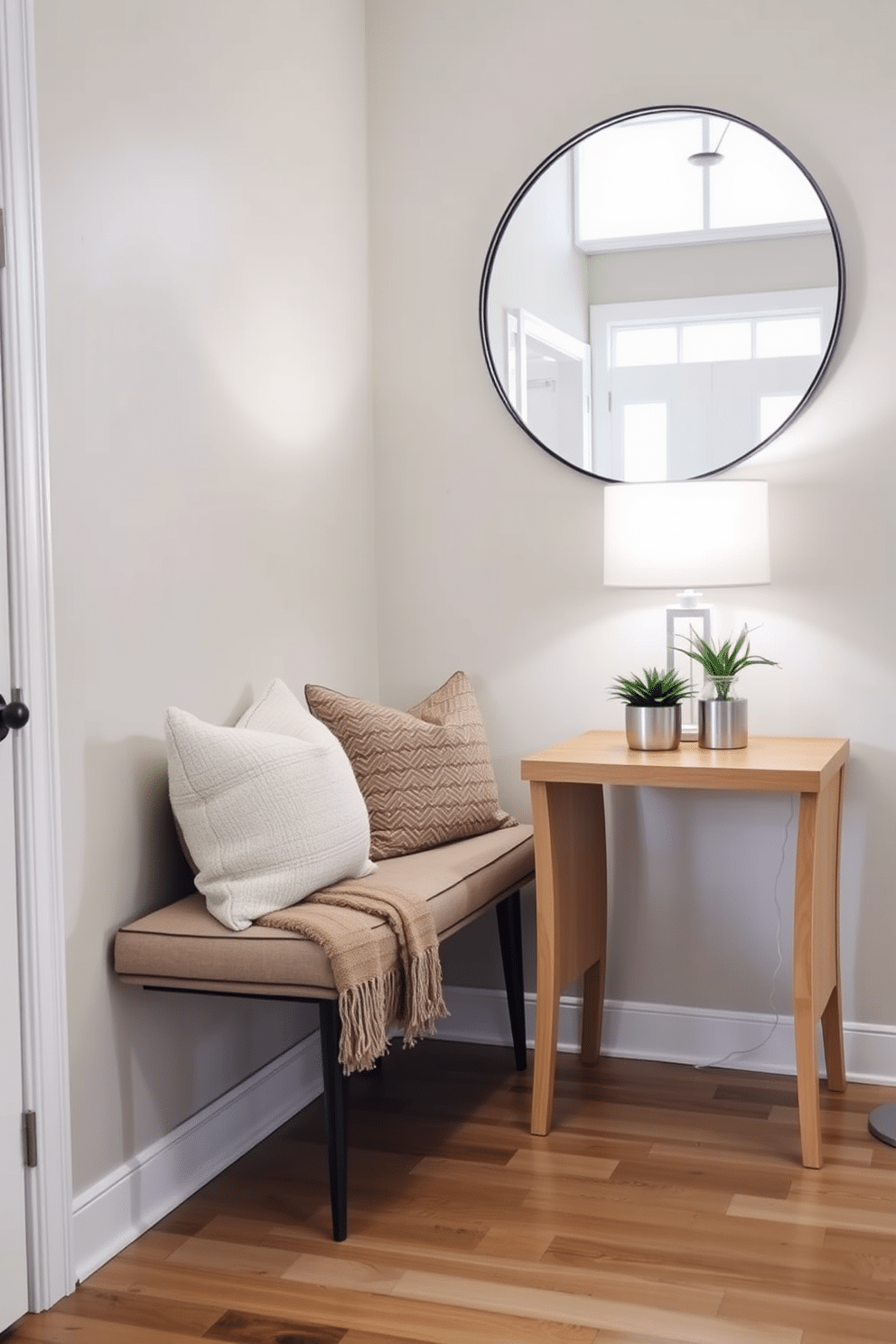 A cozy bench with plush cushions sits against a wall in a warmly lit entryway. The bench is adorned with a soft, textured throw blanket and a few decorative pillows in complementary colors, creating an inviting atmosphere. An entryway table features a sleek design with a natural wood finish, topped with a stylish lamp and a small potted plant. Above the table, a large round mirror reflects the light, enhancing the space's openness and adding a touch of elegance.