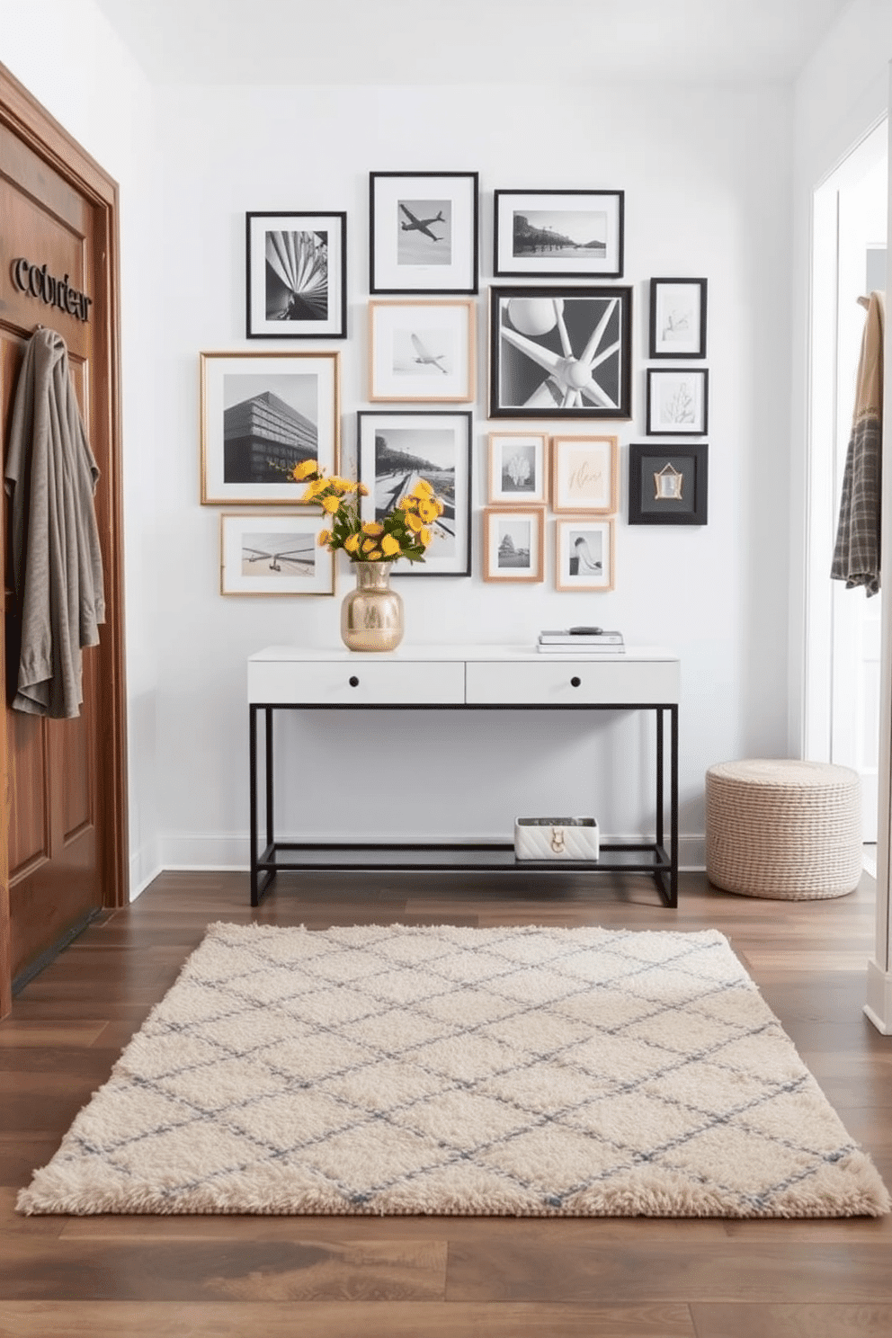 A soft area rug in a neutral tone lies at the center of the entryway, providing both comfort and a stylish touch underfoot. Surrounding the rug, the space features a mix of textures, including a sleek console table and decorative wall hooks for added functionality. The entryway wall is adorned with a gallery of framed artwork, creating an inviting focal point that showcases personal style. A subtle accent color is incorporated through decorative elements, such as a vibrant potted plant or a chic mirror, enhancing the overall aesthetic.