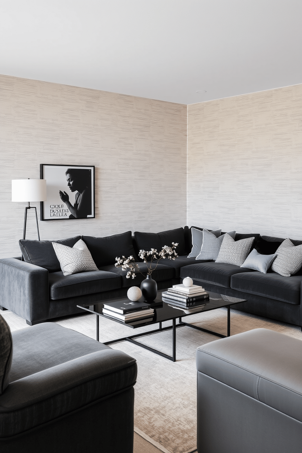 A sophisticated family room featuring a monochrome palette that combines various textures for depth and interest. The space includes a plush sectional sofa in deep charcoal, accented by a series of textured throw pillows in shades of gray and black. The walls are adorned with a subtle, textured wallpaper that adds warmth, while a large area rug in a soft, muted tone anchors the seating area. A sleek coffee table in black glass sits at the center, complemented by minimalist decor pieces and a few carefully curated books.