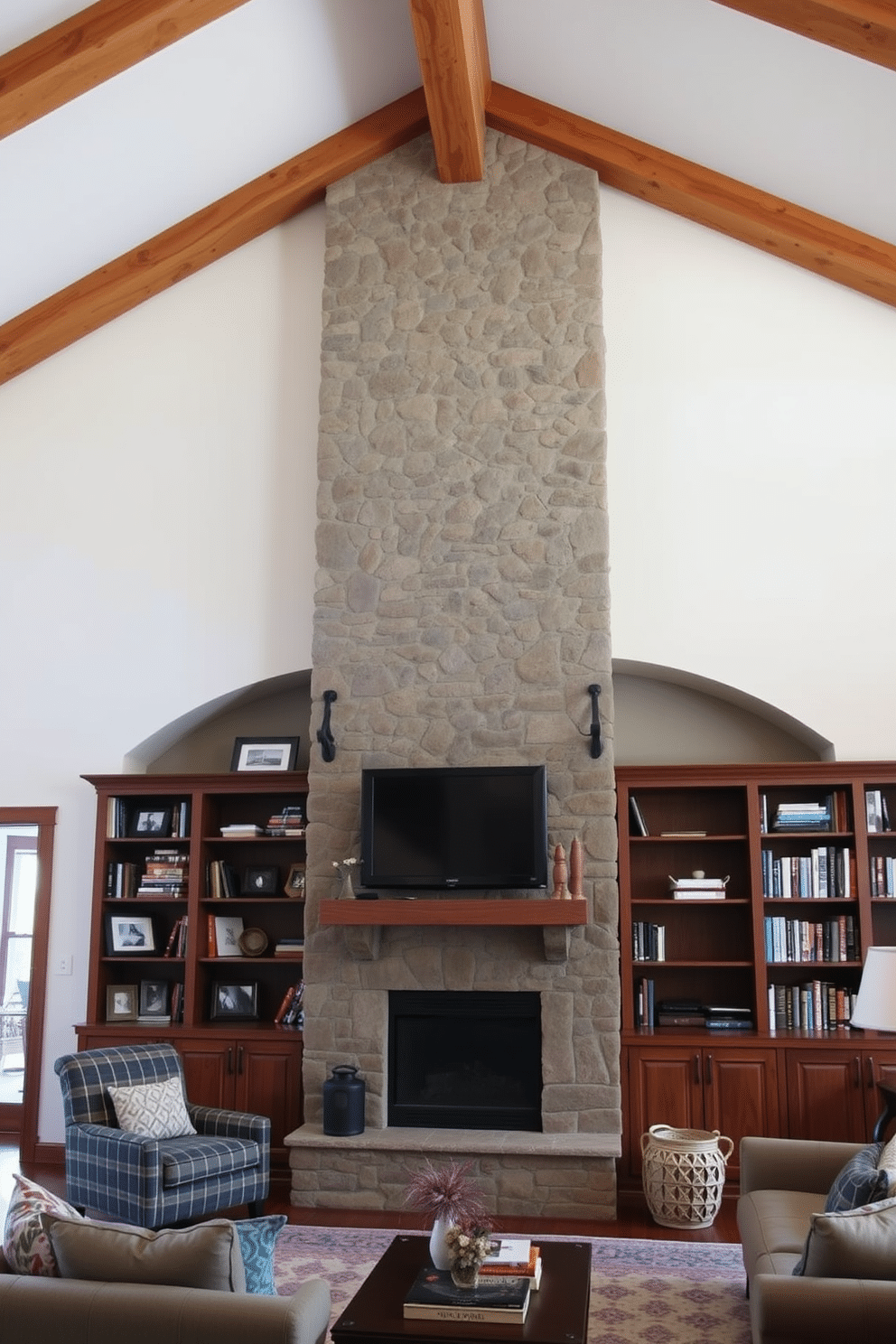 A cozy family room featuring warm wood beams that stretch across the ceiling, creating a rustic yet inviting atmosphere. The focal point is a large stone fireplace, elegantly framed by built-in bookshelves filled with family photos and cherished books.