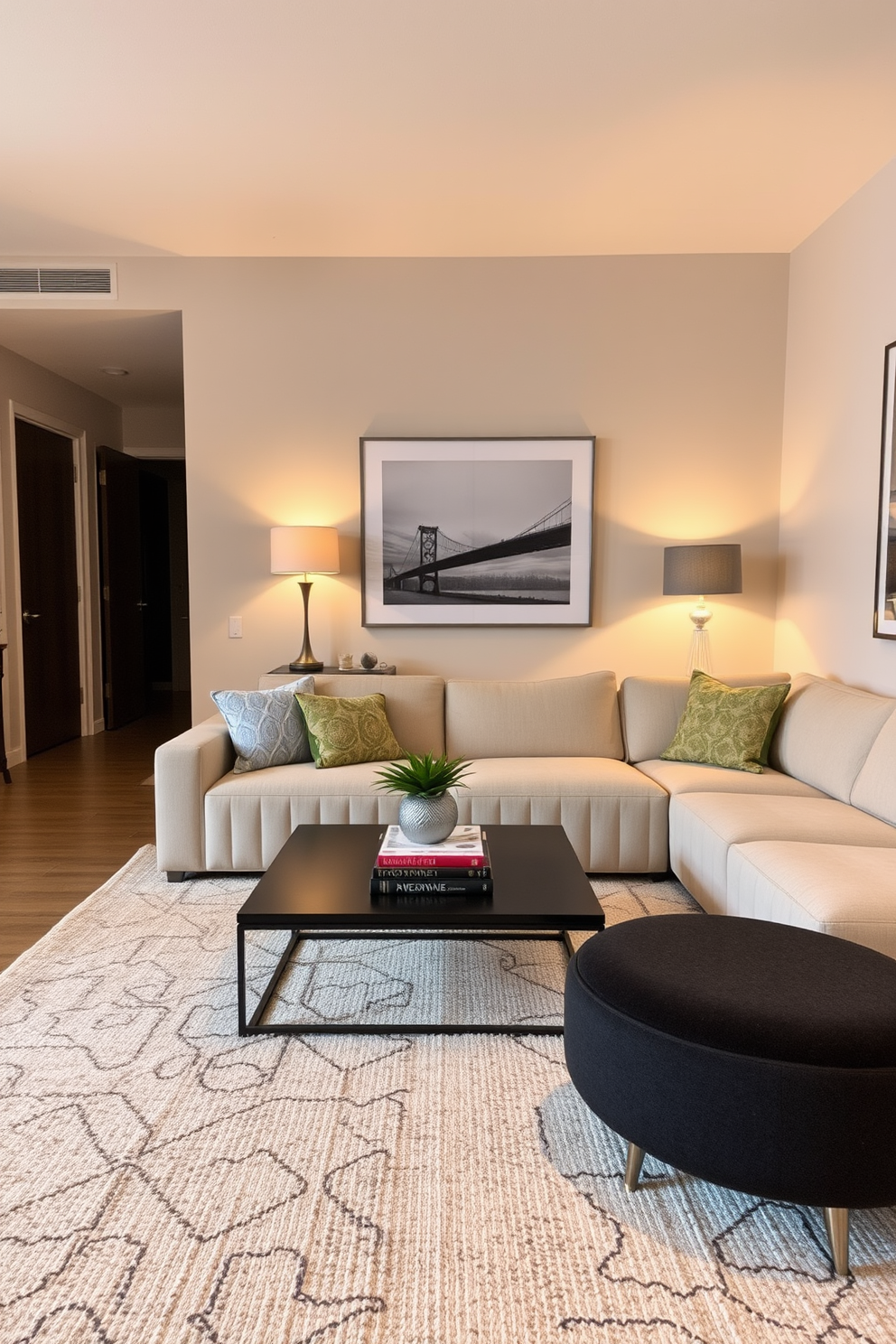 A cozy living room in a stylish apartment. Soft warm lighting emanates from elegant table lamps placed on either side of a plush sectional sofa, creating an inviting atmosphere. The walls are adorned with tasteful artwork, and a sleek coffee table sits in the center, topped with decorative books and a small plant. A textured area rug anchors the seating area, enhancing the comfort and charm of the space.