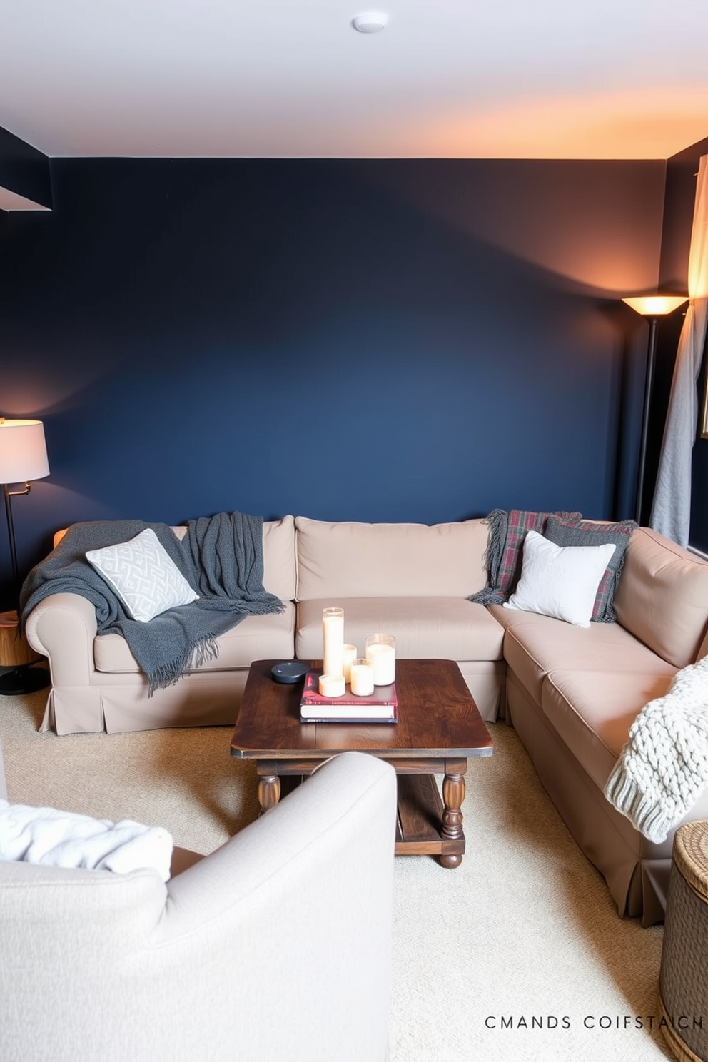 A cozy basement retreat featuring warm throws draped over a plush sectional sofa in a soft beige fabric. The walls are painted in a rich navy blue, creating a warm and inviting atmosphere, while a rustic wooden coffee table sits in the center adorned with candles and books. In one corner, a stylish armchair complements the sofa, with a knitted throw casually placed over its back. Soft ambient lighting from floor lamps enhances the comfort of the space, making it perfect for relaxation or entertaining guests.