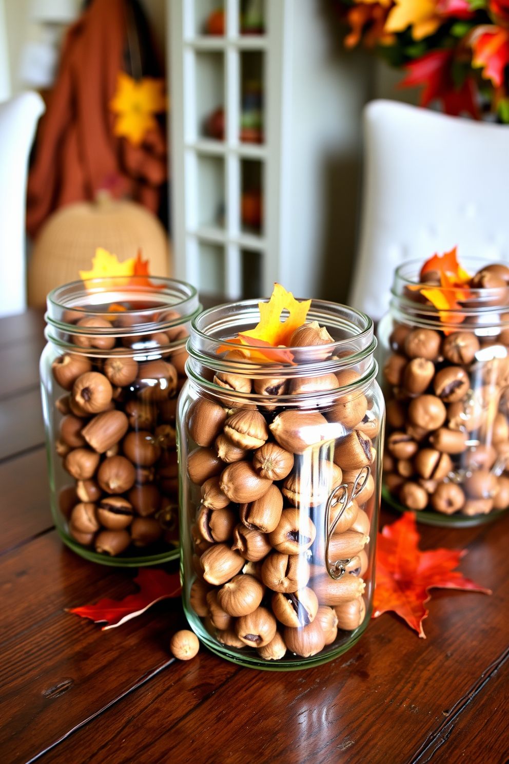 A cozy autumn display featuring mason jars filled with acorns sits on a rustic wooden table. The jars are arranged with small pumpkins and colorful leaves, creating a warm and inviting atmosphere for fall decorating.