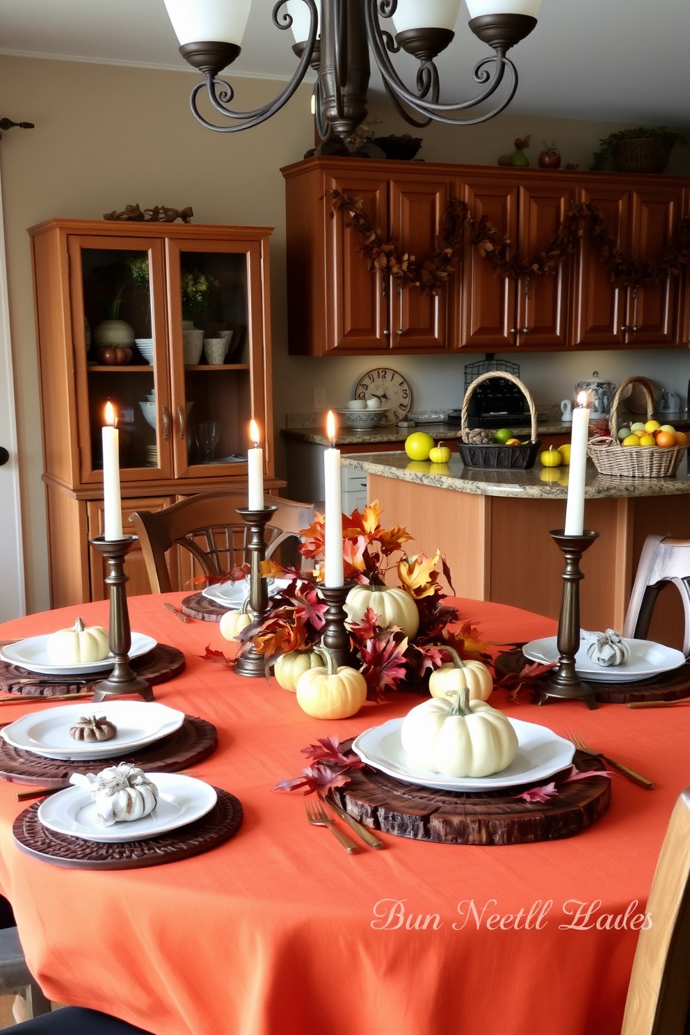 A cozy dining area adorned with autumn-themed table settings. The table is dressed in a warm orange tablecloth, featuring rustic wooden placemats and elegant white dinnerware. Centerpieces include small pumpkins and vibrant fall leaves, creating a festive atmosphere. Soft candlelight flickers from bronze candle holders, enhancing the inviting ambiance. The kitchen showcases fall decorations with garlands of dried leaves hanging above the cabinets. A basket filled with seasonal fruits sits on the countertop, adding a touch of warmth and color.