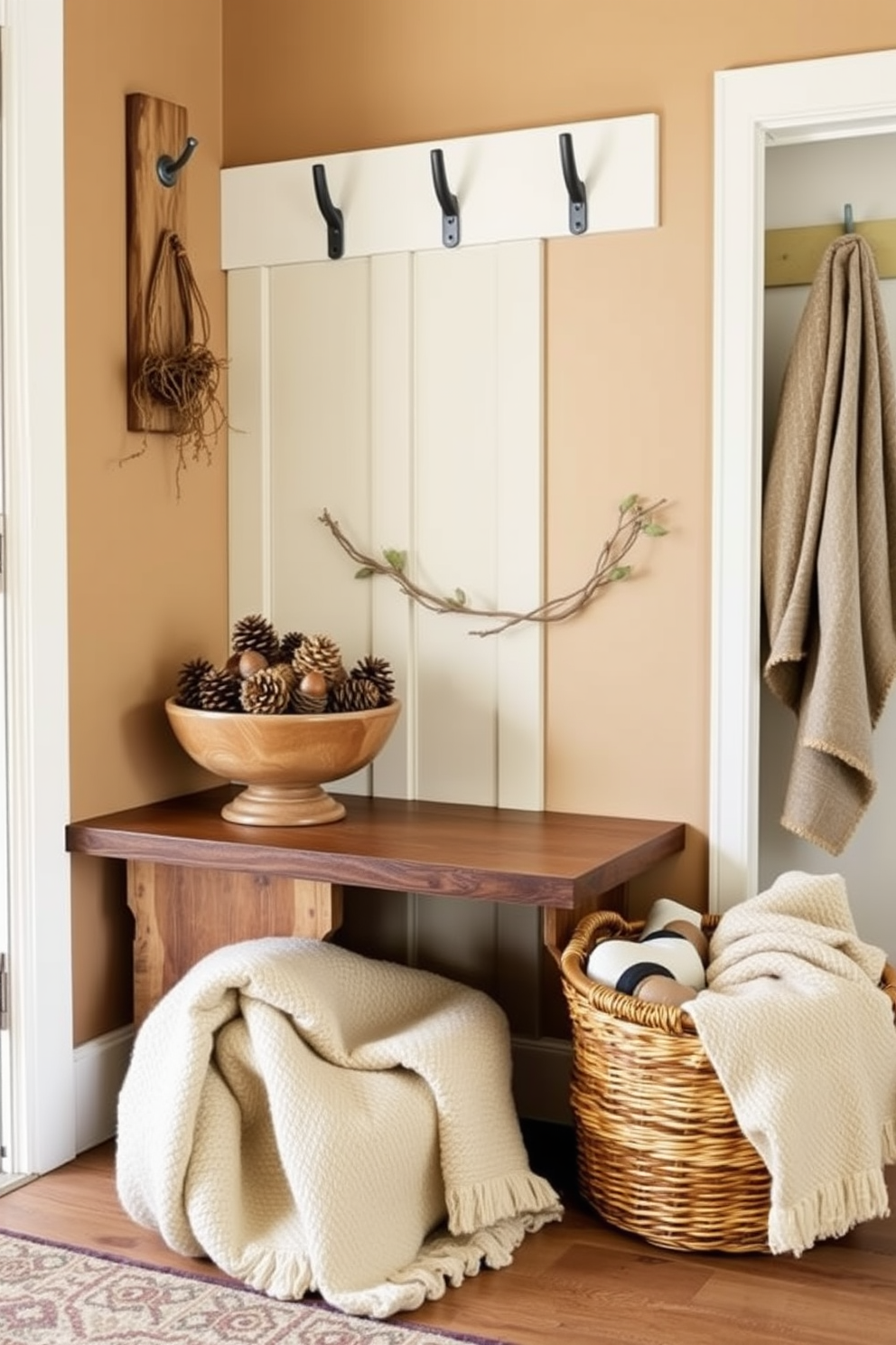 A cozy mudroom filled with natural elements. Pinecones and acorns are artfully arranged in a wooden bowl on a rustic bench. The walls are painted in a soft earth tone, creating a warm and inviting atmosphere. A woven basket sits on the floor, filled with cozy blankets and seasonal decor.