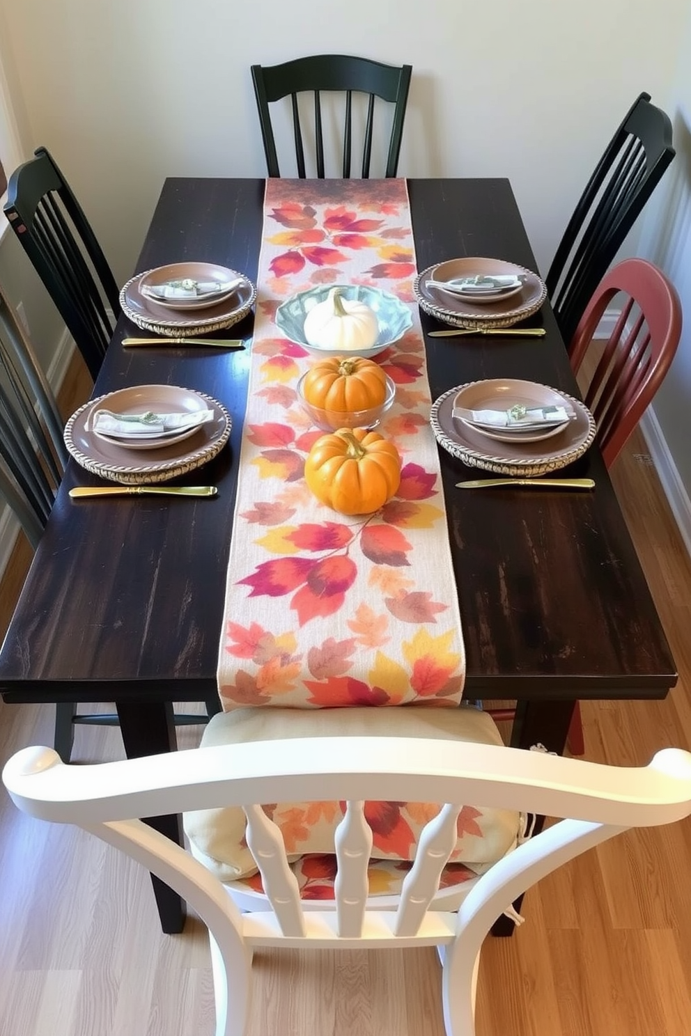 A cozy dining space adorned with a seasonal table runner featuring warm autumn hues. The table is set with rustic ceramic plates, golden cutlery, and small pumpkins as centerpieces. In a compact area, a stylish table is decorated with a vibrant fall-themed runner that adds a pop of color. Surrounding the table are mismatched chairs, creating an inviting and eclectic atmosphere perfect for gatherings.