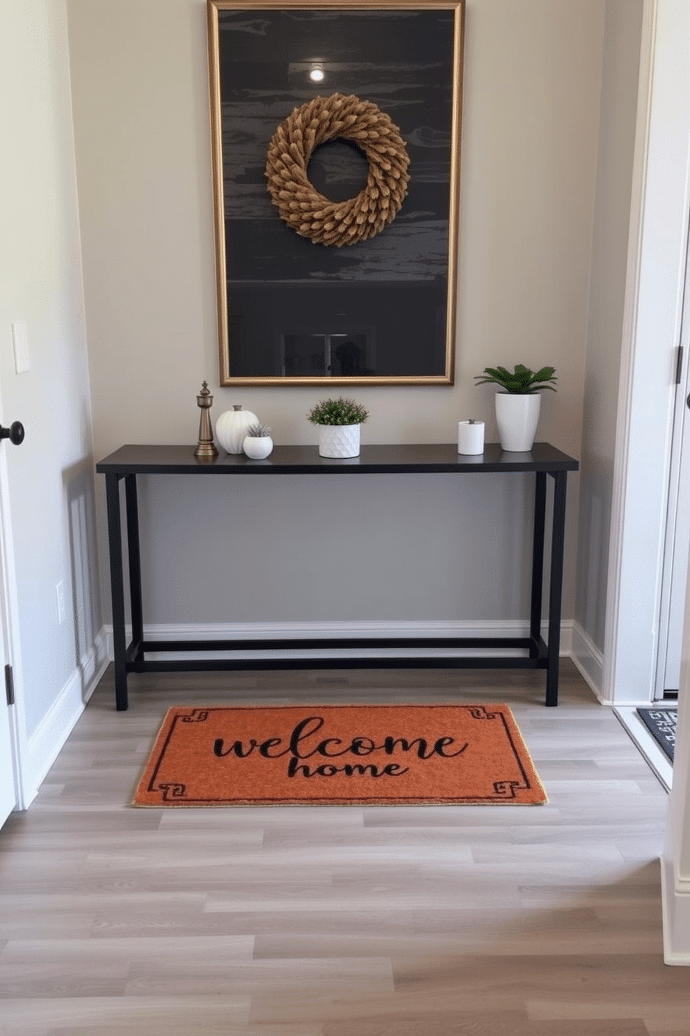 A welcoming foyer featuring a stylish doormat with a personalized message, inviting guests into the home. The walls are painted in a soft, neutral tone, complemented by a chic console table adorned with decorative items and a small potted plant.