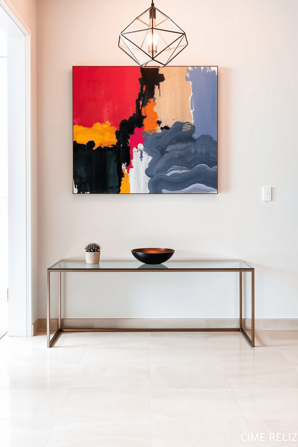 A sleek modern foyer features a minimalist console table with a glass top and a thin metal frame, positioned against a light gray wall. A large abstract painting in vibrant colors hangs above the table, complemented by a small potted plant and a stylish bowl for keys. The floor is adorned with large-format porcelain tiles in a neutral tone, creating a seamless look that enhances the spacious feel. A statement pendant light with geometric shapes hangs from the ceiling, casting a warm glow over the entryway.