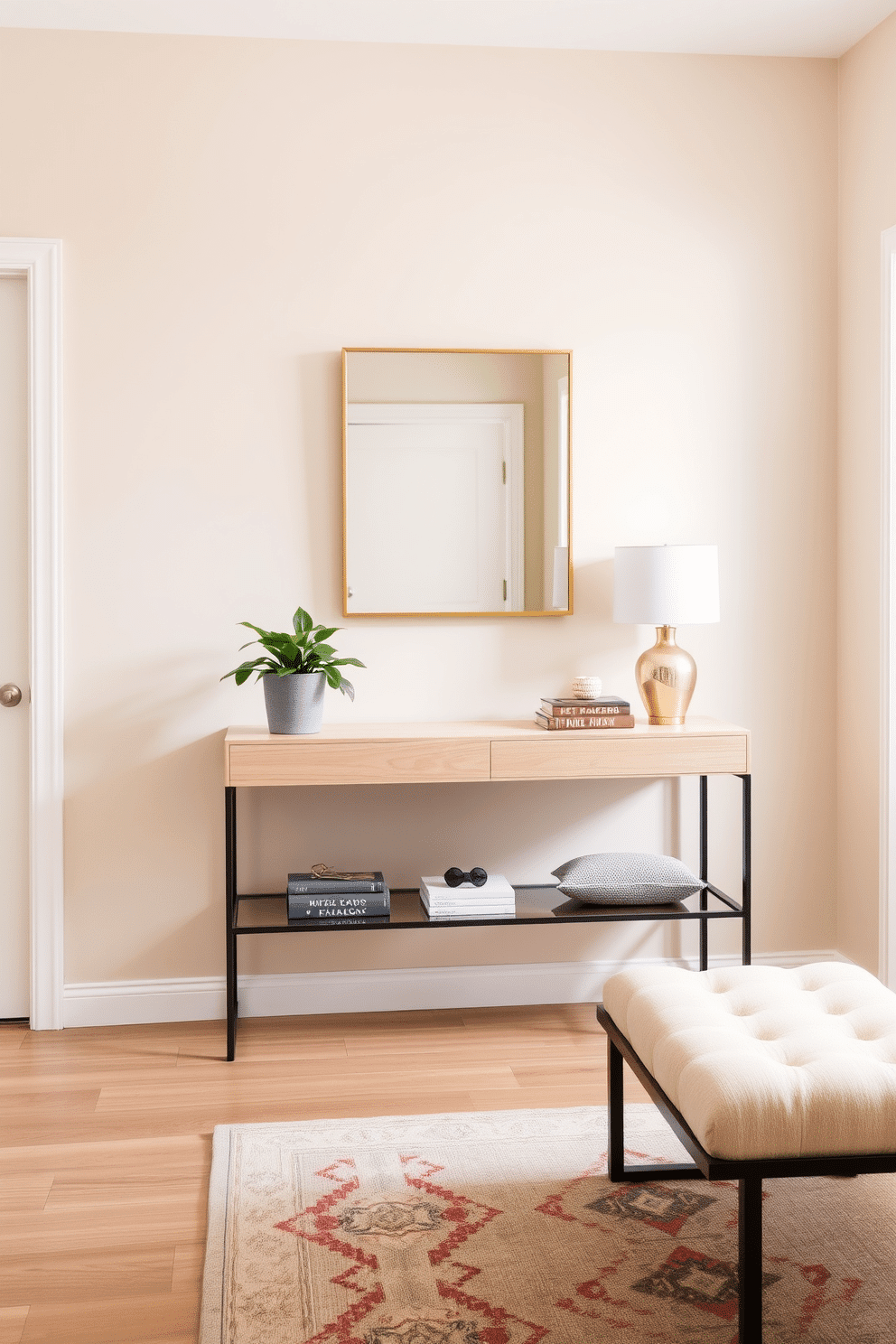 A welcoming foyer features a sleek console table in a light wood finish, adorned with a small potted plant that adds a touch of greenery. The walls are painted in a soft beige, complemented by a statement mirror with a minimalist gold frame, enhancing the natural light that floods the space. A stylish area rug in muted tones anchors the space, while a small bench with plush cushions provides a comfortable spot for putting on shoes. Decorative elements, such as a few curated books and a chic lamp, bring personality to the foyer without overwhelming the neutral color palette.