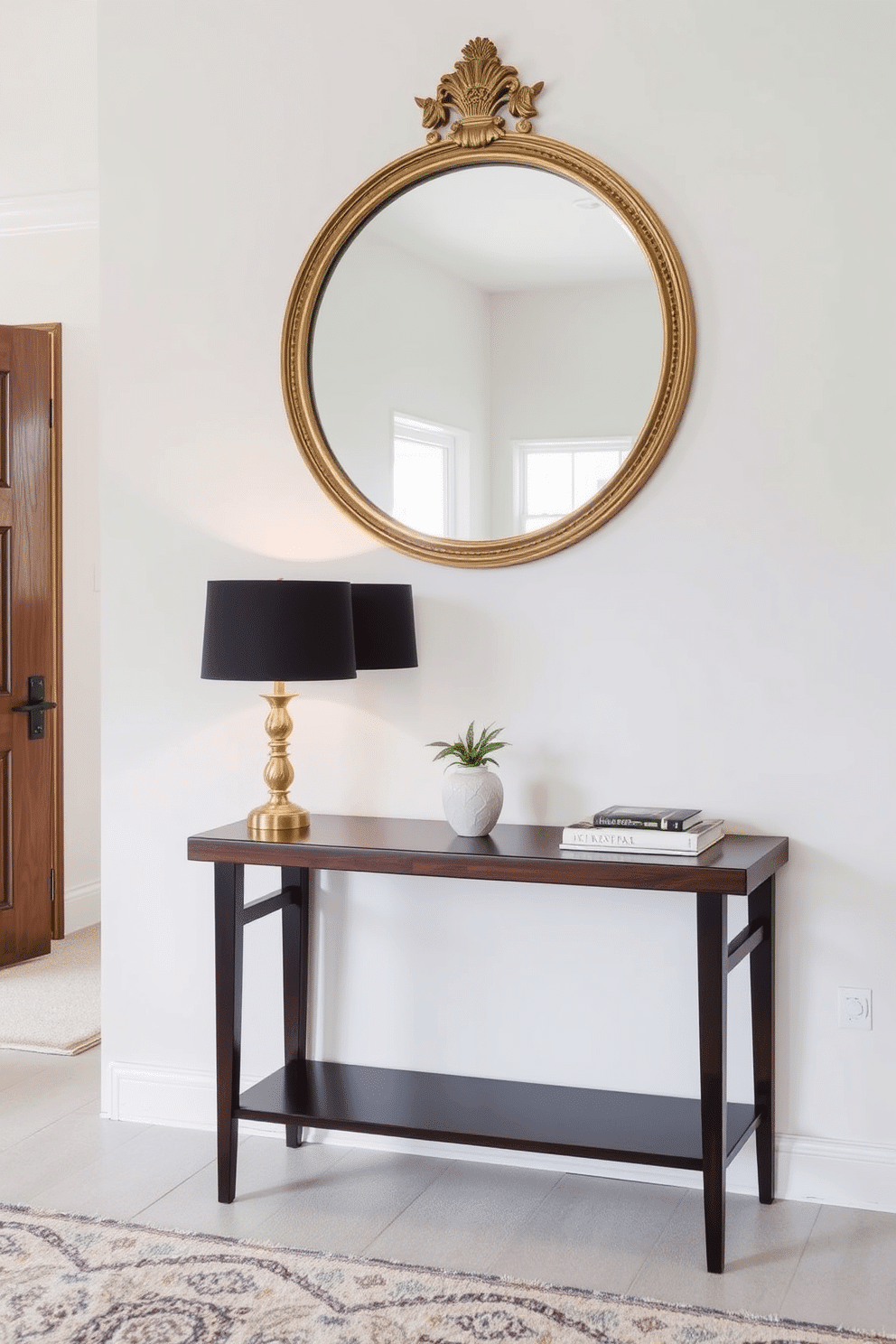 A chic console table with a decorative mirror is the centerpiece of the foyer entryway. The table features a sleek, dark wood finish and is adorned with a stylish lamp, a small potted plant, and a stack of art books. Above the table, a large, round mirror with an ornate gold frame reflects the light, enhancing the space's brightness. The walls are painted in a soft, neutral tone, and a plush area rug in muted colors adds warmth underfoot.