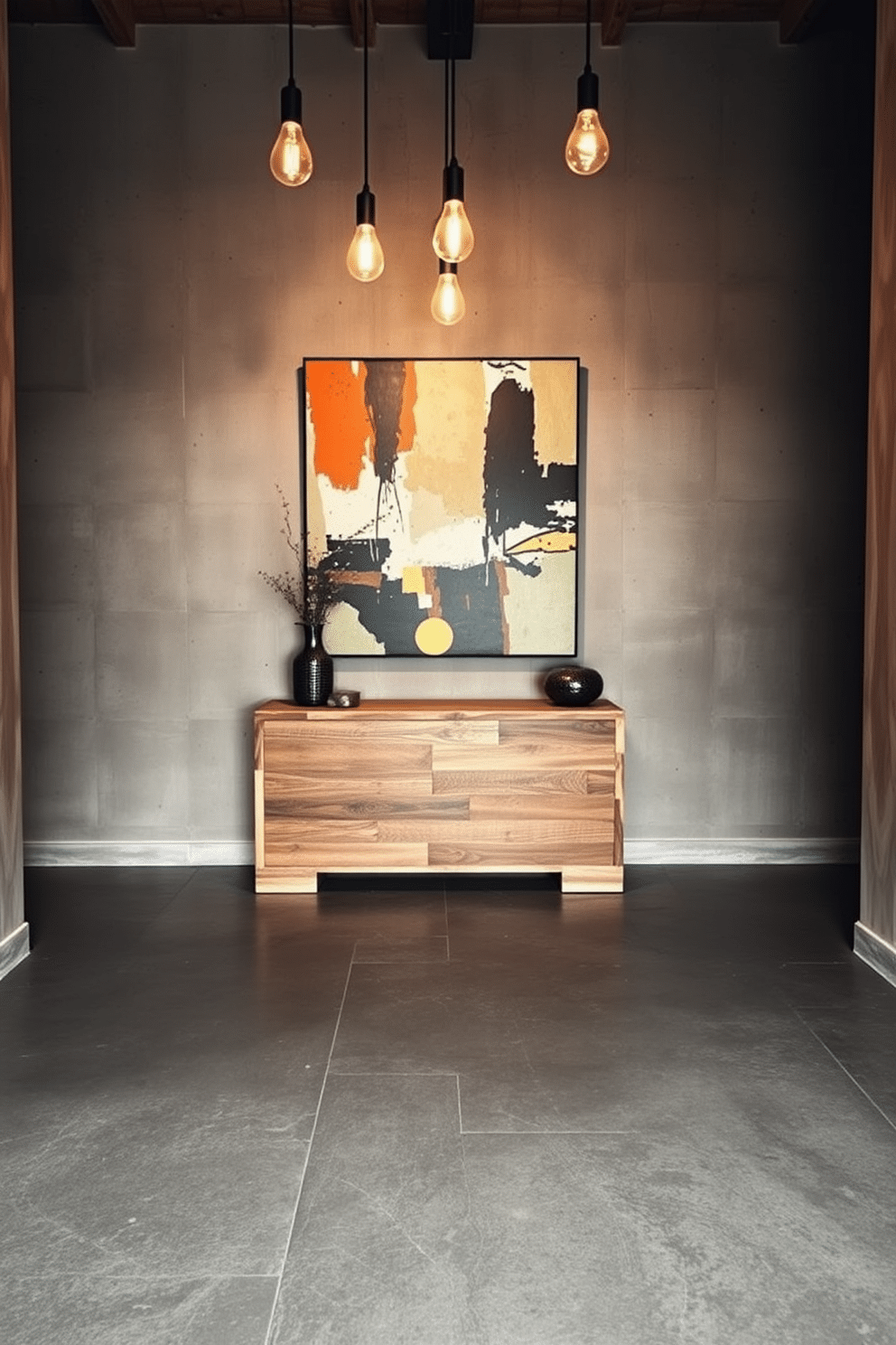 A striking foyer featuring textured concrete tiles that enhance the industrial aesthetic. The space is illuminated by pendant lights with exposed bulbs, casting a warm glow on the raw, unfinished walls. In the center, a sleek console table made of reclaimed wood offers a stylish contrast to the rugged flooring. A large abstract artwork hangs above, adding a pop of color and personality to the entryway.