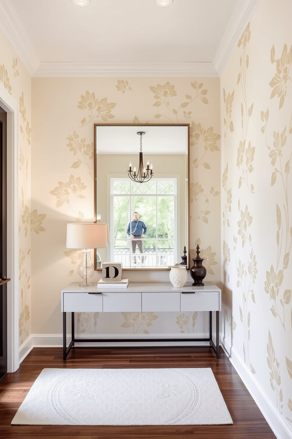 A stunning foyer featuring a stenciled design that adds a personalized touch to the space. The walls are painted in a soft cream color, adorned with intricate floral stencils in a muted gold tone, creating an elegant and welcoming atmosphere. A sleek console table sits against the wall, topped with a stylish lamp and a few curated decorative items. Above the table, a large mirror reflects the beautiful stenciled patterns, enhancing the sense of depth and light in the foyer.