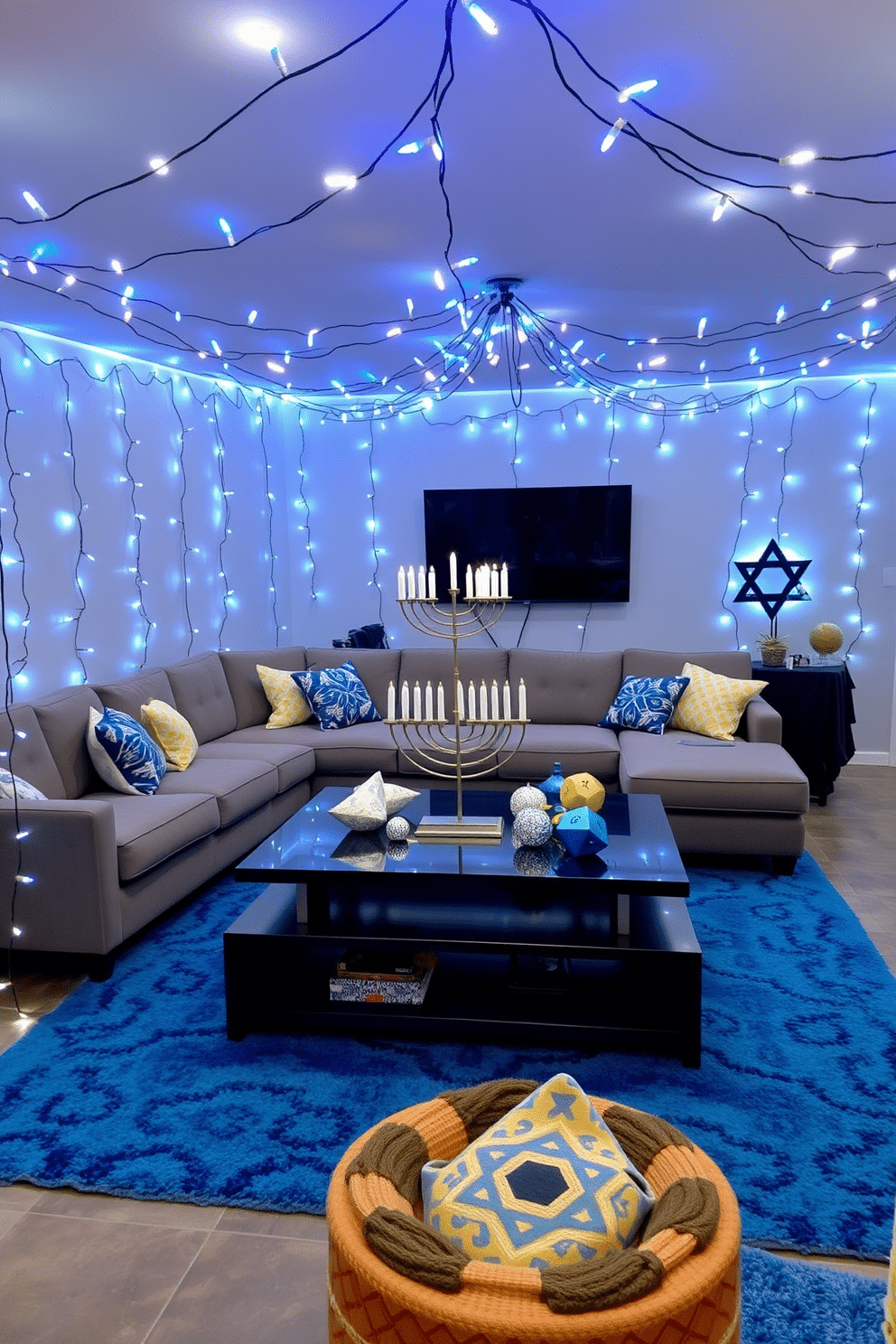 A cozy game room adorned with blue and white fairy lights, creating a whimsical atmosphere perfect for gatherings. The walls are painted a soft gray, and a plush sectional sofa is positioned around a sleek coffee table, inviting relaxation and fun. Decorated for Hanukkah, the room features a large menorah on the table, surrounded by festive decorations. A vibrant blue rug anchors the space, while colorful dreidels and Star of David ornaments add a playful touch to the overall design.