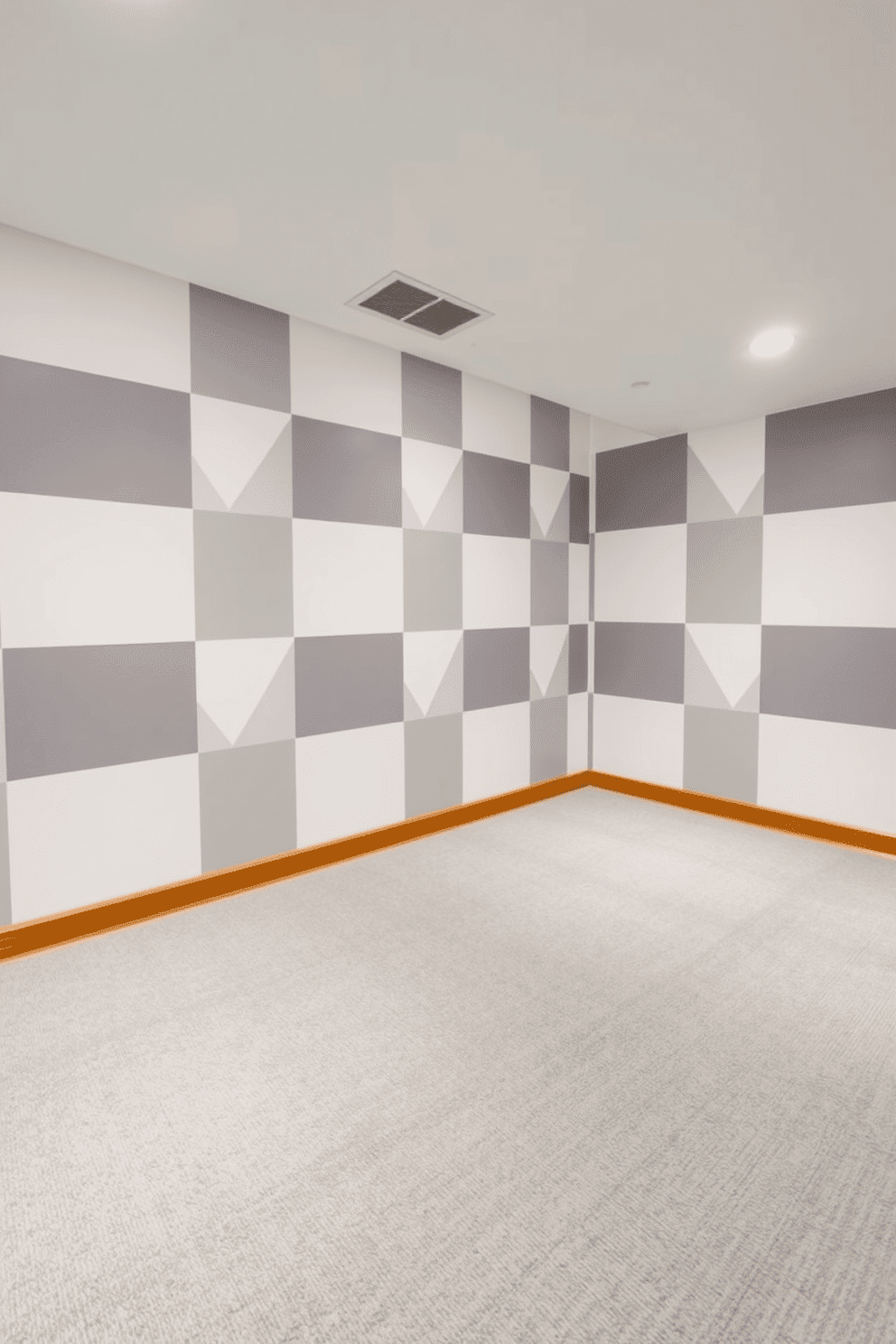 A modern basement featuring geometric patterns in gray and white. The walls are adorned with large-scale geometric wallpaper, while the floor showcases a sleek gray carpet with subtle white accents.