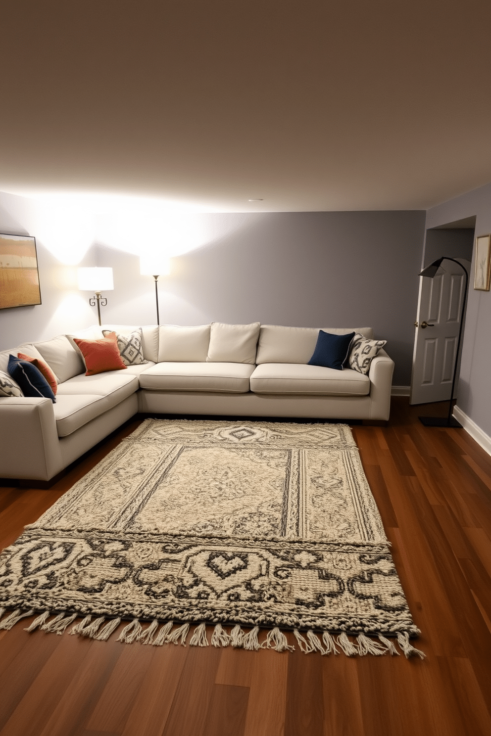 A cozy gray basement design featuring layered rugs that add texture and warmth to the space. The walls are painted in a soft gray tone, complemented by a plush, light gray sectional sofa adorned with colorful throw pillows. In the center, a large, patterned area rug anchors the seating area, while smaller, textured rugs are layered on top for added depth. Ambient lighting from stylish floor lamps casts a warm glow, enhancing the inviting atmosphere of the basement retreat.