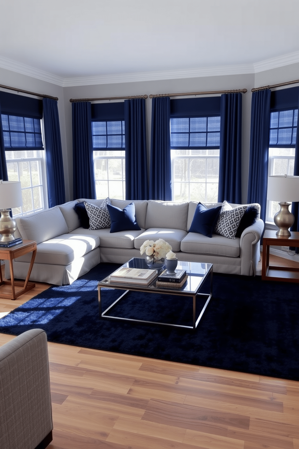 A classic family room featuring a gray sectional sofa adorned with navy blue accent pillows. The walls are painted a soft gray, complemented by navy blue curtains that frame the large windows, allowing natural light to flood the space. In the center, a sleek coffee table with a glass top rests on a plush navy blue area rug. Flanking the sofa, a pair of modern wooden side tables hold stylish lamps, adding warmth and sophistication to the room.