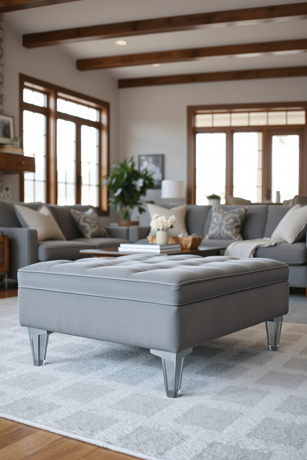 A stylish gray ottoman is placed in a cozy family room, providing extra seating and a touch of elegance. The ottoman features a plush fabric upholstery and sleek legs, complementing the room's modern aesthetic. The family room is designed with a neutral color palette, accented by soft gray tones and warm wooden elements. Large windows allow natural light to flood the space, highlighting the inviting atmosphere and comfortable seating arrangements.