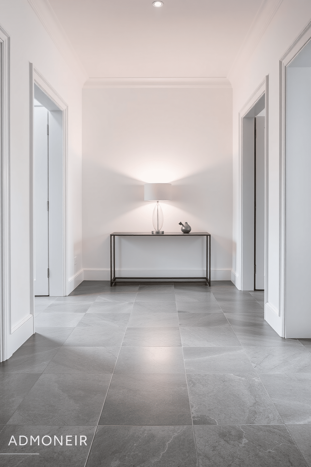 A striking foyer featuring geometric gray tiles that create a visually captivating floor pattern. The walls are painted in a soft white, accentuating the modern design while a sleek console table with a minimalist lamp adds functionality and style.