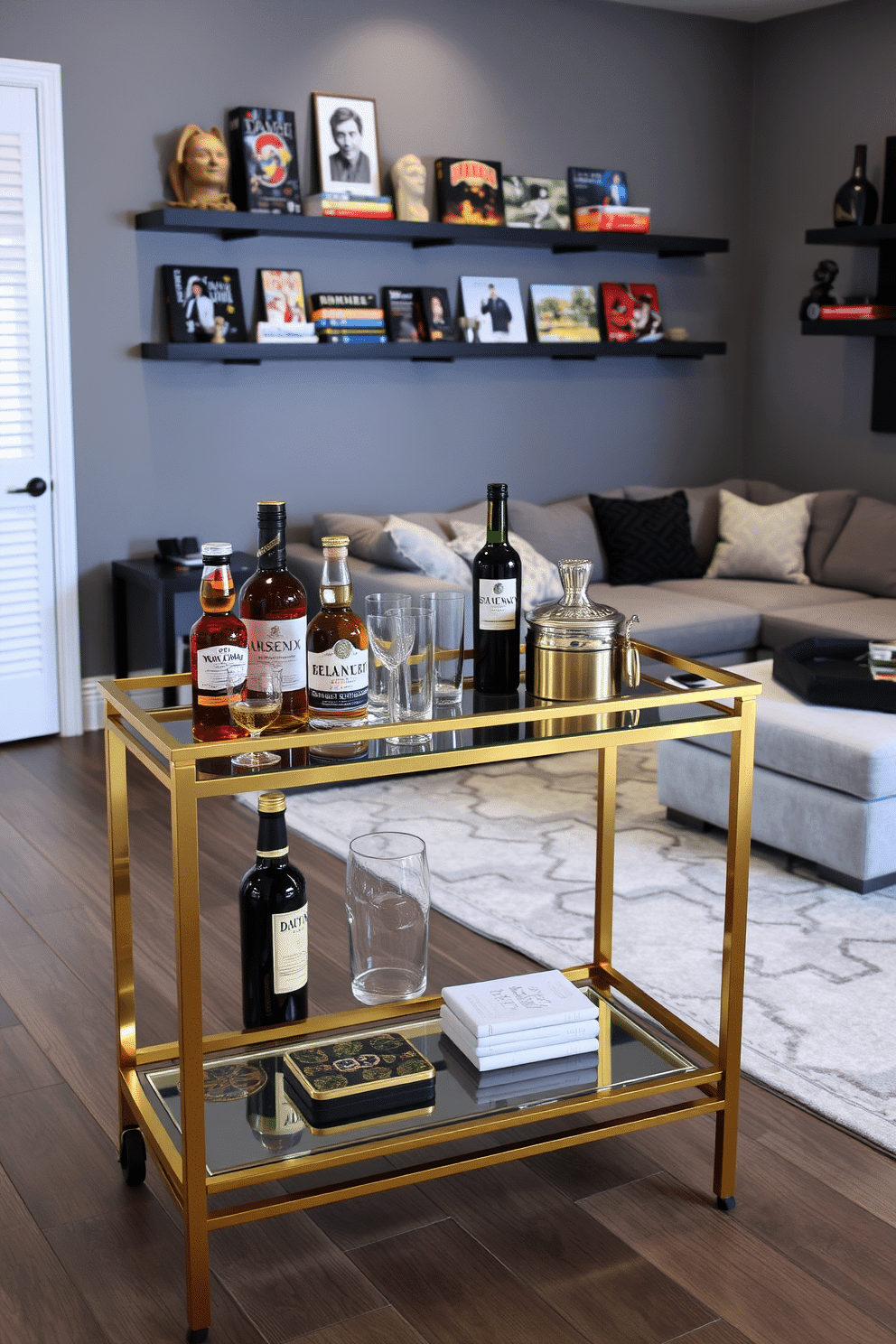 A stylish bar cart designed for entertaining guests features a sleek, modern frame with a polished gold finish. The top is adorned with an assortment of premium spirits, elegant glassware, and a small ice bucket, while the lower shelf holds artisanal mixers and decorative coasters. The gray game room design includes a plush sectional sofa upholstered in a soft, textured fabric, complemented by a large, abstract area rug. Wall-mounted shelves display an array of board games and collectibles, and ambient lighting creates a cozy atmosphere, perfect for gatherings.