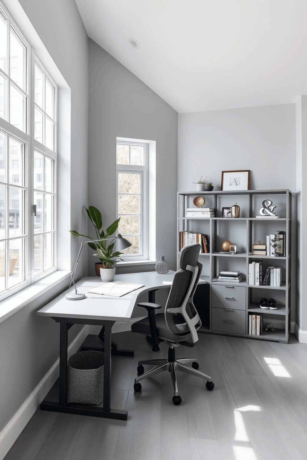 A bright gray workspace filled with natural light from large windows that stretch across one wall. The room features a sleek gray desk paired with a comfortable ergonomic chair, and a minimalist bookshelf lined with stylish decor and books.