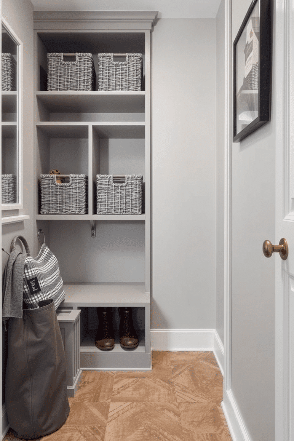 A stylish mudroom featuring open shelving adorned with gray baskets for organized storage. The walls are painted in a soft gray hue, complemented by a durable, textured flooring that enhances the overall aesthetic.