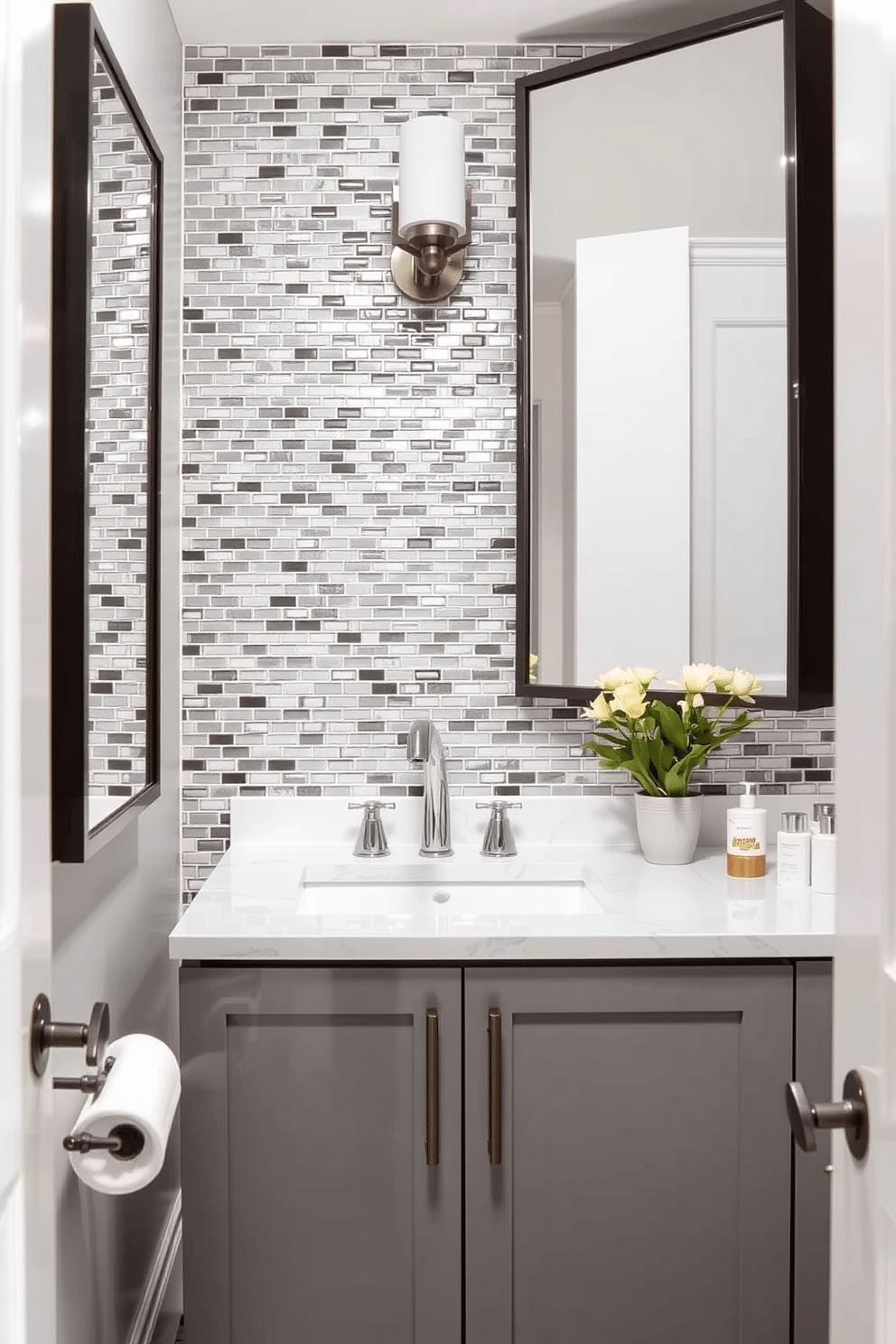 A chic powder room featuring a gray mosaic tile backsplash that adds a touch of elegance and interest. The space is complemented by sleek fixtures and a minimalist gray vanity, creating a harmonious and modern aesthetic.