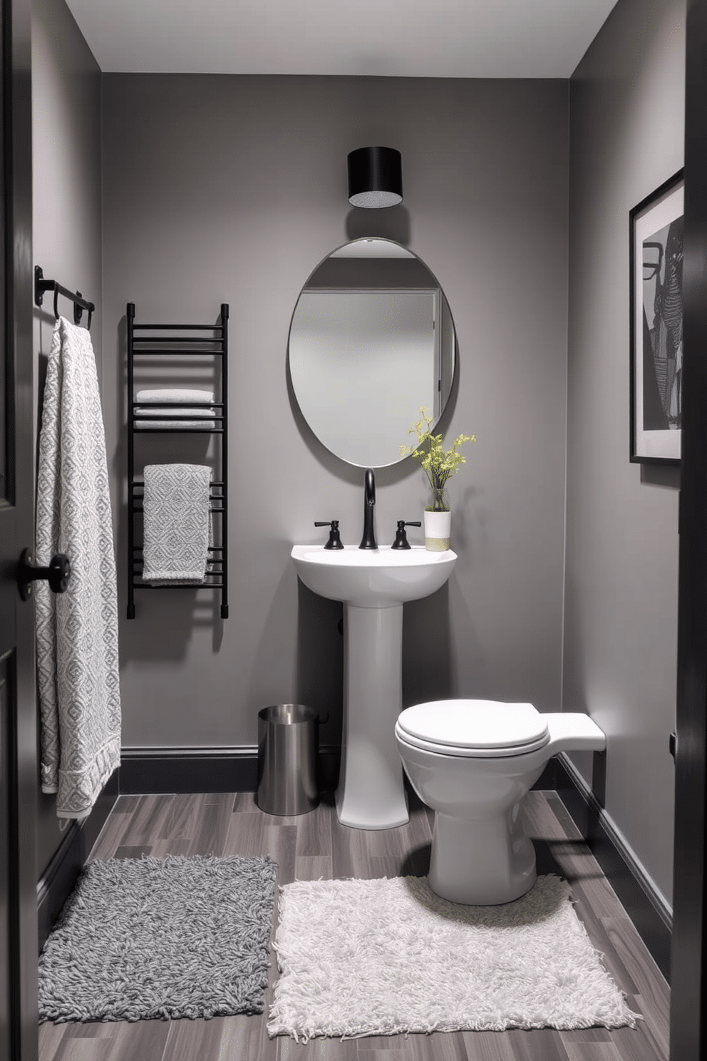 A stylish gray powder room featuring layered gray rugs that add texture and warmth to the space. The walls are painted in a soft gray hue, complemented by sleek black fixtures and a modern pedestal sink.