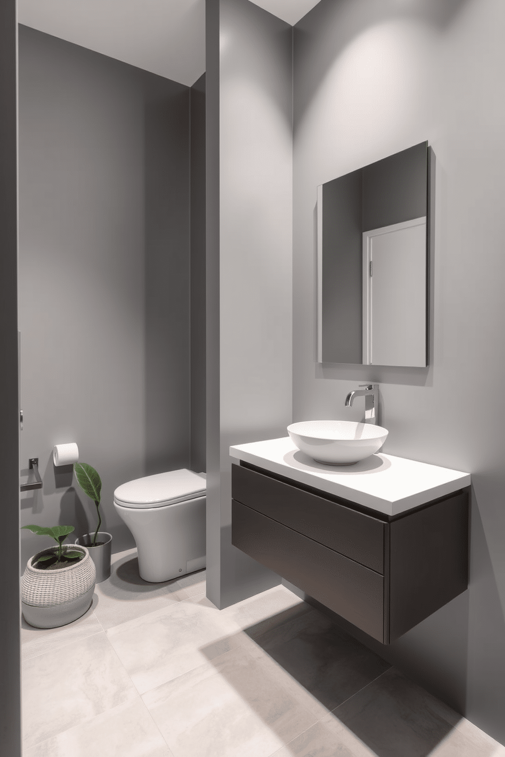 A sleek gray powder room features minimalist fixtures that embody modern elegance. The walls are adorned with a soft gray hue, complemented by a floating vanity with a clean, white countertop and a stylish vessel sink. A frameless mirror reflects the simplicity of the design, while subtle lighting enhances the space's ambiance. The floor is finished with large, light gray tiles that create a seamless look, and a small potted plant adds a touch of greenery.