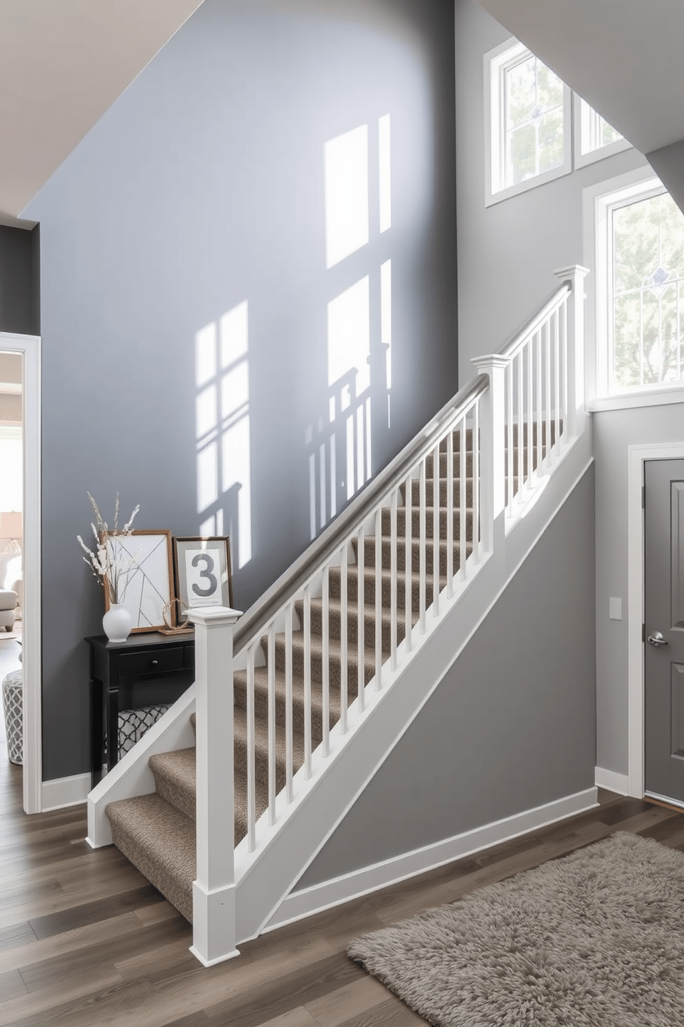 A striking gray accent wall serves as a dramatic backdrop for the elegant staircase, enhancing the overall aesthetic of the entryway. The staircase features sleek, minimalist railings and a plush runner that adds warmth and texture to the modern design. The gray tones create a cohesive look, seamlessly blending with surrounding decor elements. Natural light filters through nearby windows, casting soft shadows that highlight the architectural details of the staircase.