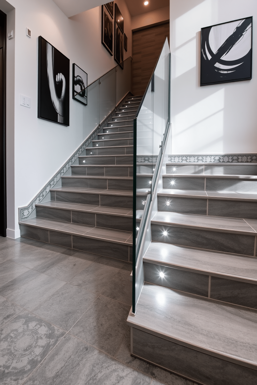 A stunning gray tile staircase features intricate decorative accents along the edges, creating a striking visual appeal. The stairs are complemented by a sleek glass railing that enhances the modern aesthetic while allowing natural light to flow through the space. The walls adjacent to the staircase are adorned with minimalist artwork, adding a touch of sophistication. Soft recessed lighting illuminates the steps, highlighting the texture of the gray tiles and enhancing the overall ambiance of the area.