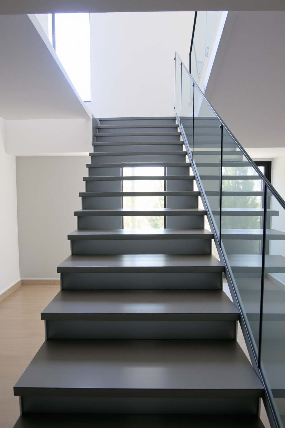 A stunning open riser staircase features sleek gray treads that create a modern and airy feel. The staircase is framed by a minimalist glass railing, allowing natural light to flow through the space and enhance the overall design.